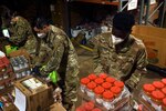 Spc. Tyree Carpenter, a combat engineer with the Virginia Army National Guard’s D Company, 229th Brigade Engineer Battalion, packages food for distribution as part of his unit’s COVID-19 response effort in Fredericksburg, Virginia, May 1, 2020. Carpenter and about 30 other Soldiers with 229th BEB were augmenting civilian personnel at an area food bank.