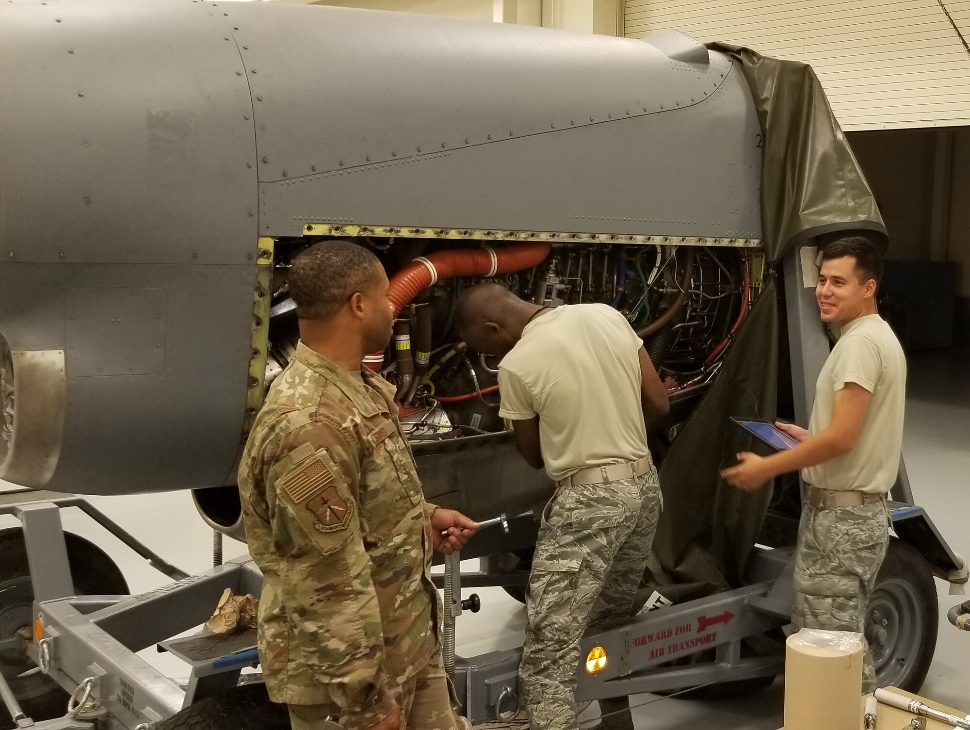 (left to right) Senior Airmen Damien Lewis, Gerald Bell, and Cristian Botello, 403rd Maintainence Squadron engine mechanics, work on the engine of a C-130J Super Hercules during a unit trainng assembly weekend. (U.S. Air Force photo by Master Sgt. Katherine Wheelock)