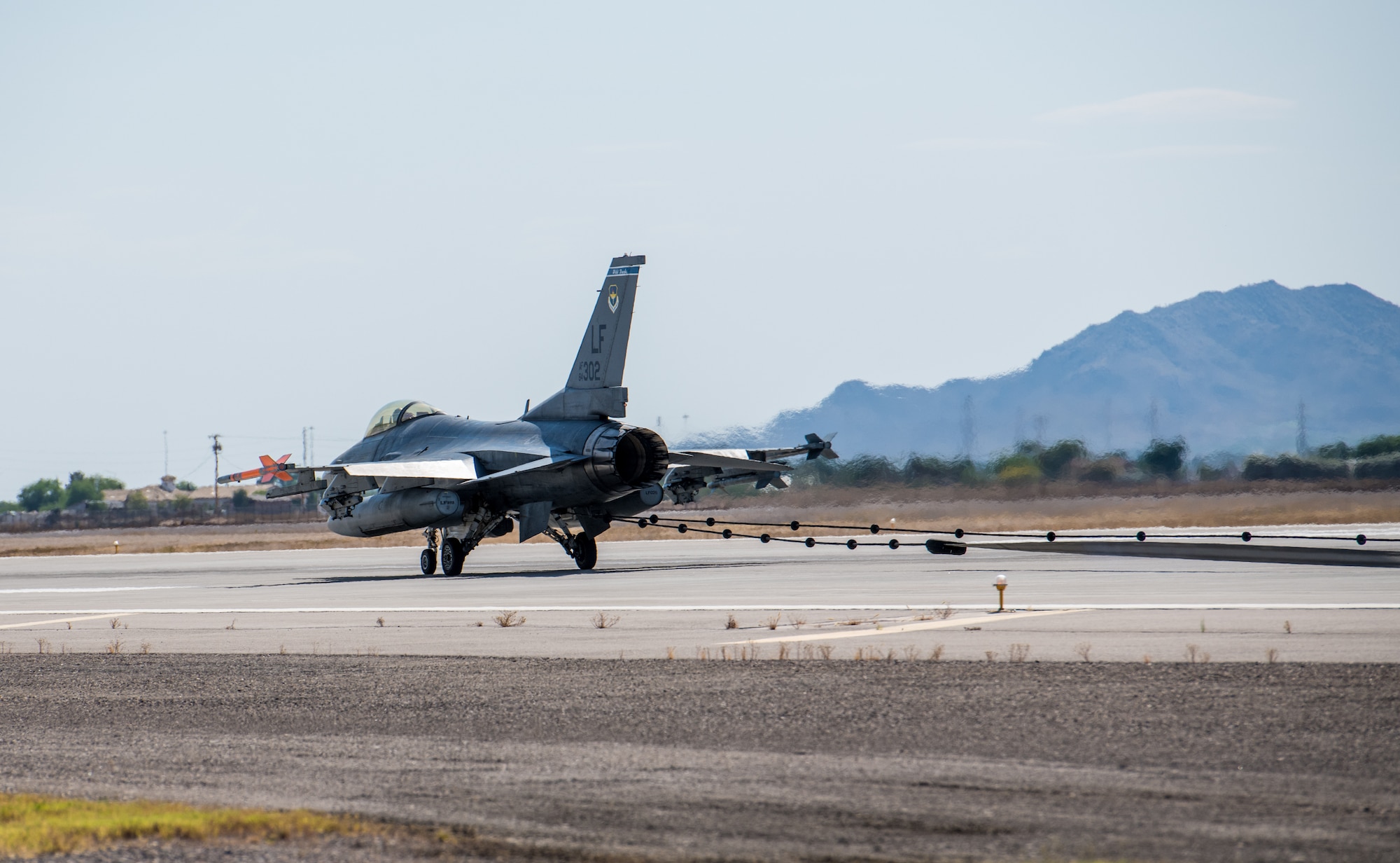 An F-16C Fighting Falcon stops after catching an emergency cable during an annual drill to recertify the BAK-12 arresting system May 8, 2020, at Luke Air Force Base, Ariz.