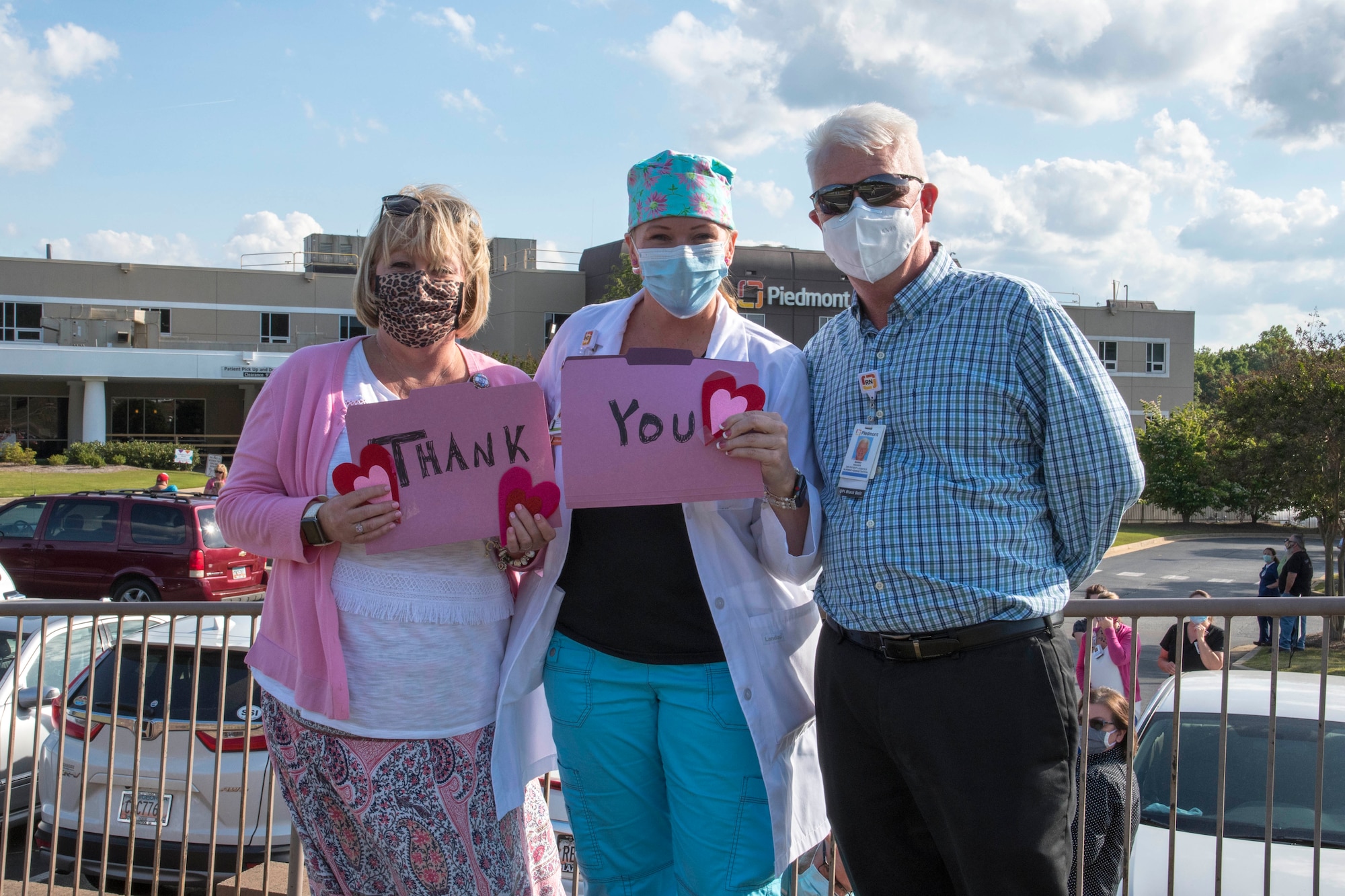 Barry Weaver, a registered nurse at Piedmont Mountainside, right, and other healthcare workers pose for a photo shortly before two C-130H3 Hercules from Dobbins performed a flyover of the hospital in Jasper, Ga. on May 14, 2020. The hospital flyover was one of several that day, serving as a way of saying thanks for all the tireless work healthcare workers and first responders have put in to help keep Georgia safe. (U.S. Air Force photo/Andrew Park)