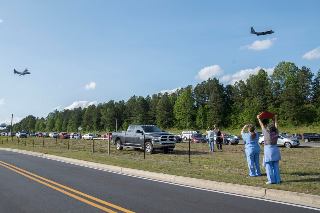 Healthcare workers from Piedmont Mountainside in Jasper, Ga. hold up a sign as two C-130H3 Hercules from Dobbins perform a flyover for the hospital on May 14, 2020. The hospital flyover was one of several that day, serving as a way of saying thanks for all the tireless work healthcare workers and first responders have put in to help keep Georgia safe. (U.S. Air Force photo/Andrew Park)