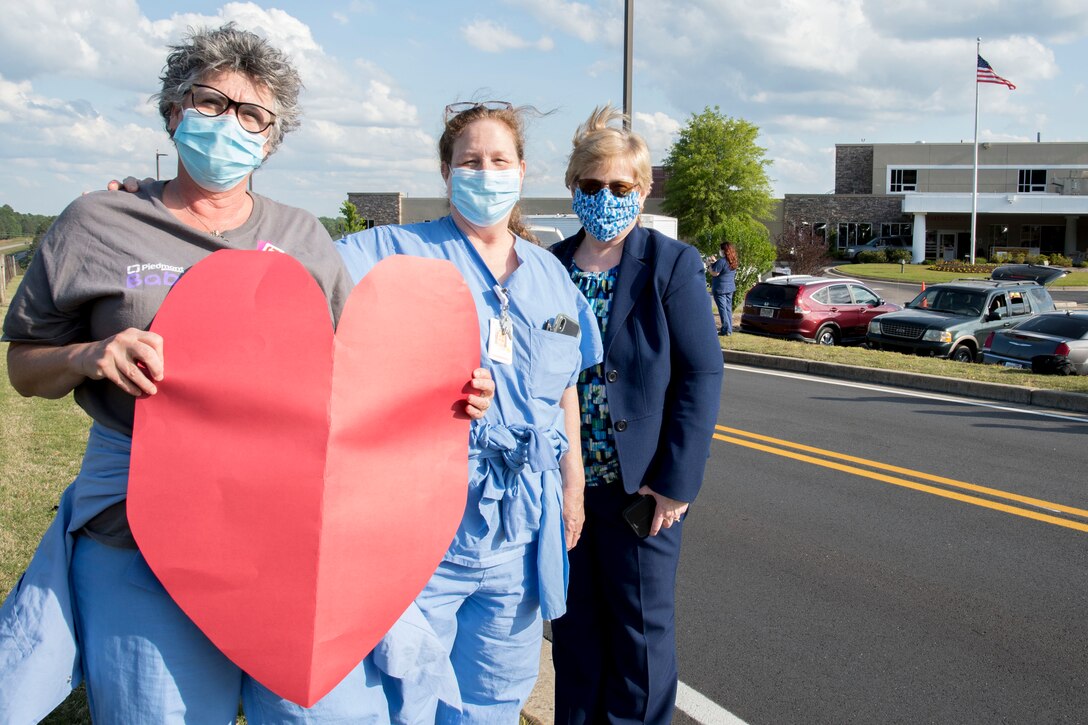 Healthcare workers from Piedmont Mountainside in Jasper, Ga. pose for a photo with a sign they created to show their appreciation for the flyover from two C-130H3 Hercules from Dobbins on May 14, 2020. The hospital flyover was one of several that day, serving as a way of saying thanks for all the tireless work healthcare workers and first responders have put in to help keep Georgia safe. (U.S. Air Force photo/Andrew Park)
