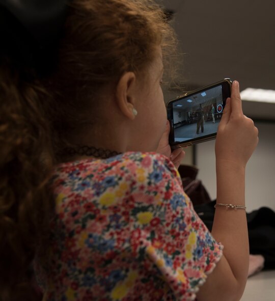 Young girl looks at phone