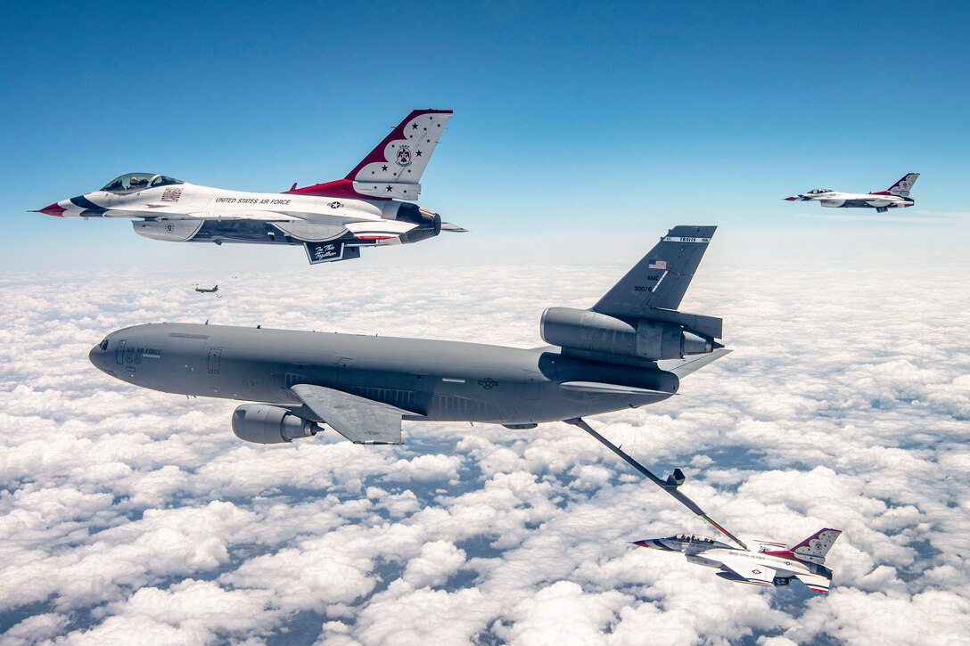 An Air Force aircraft refuels another while flying.