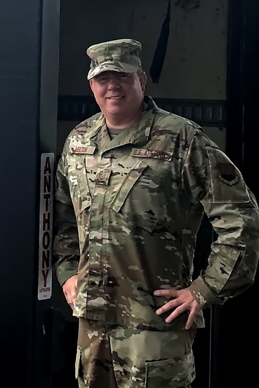 Photo of Tech. Sgt. Melton in his uniform, hands on hips.