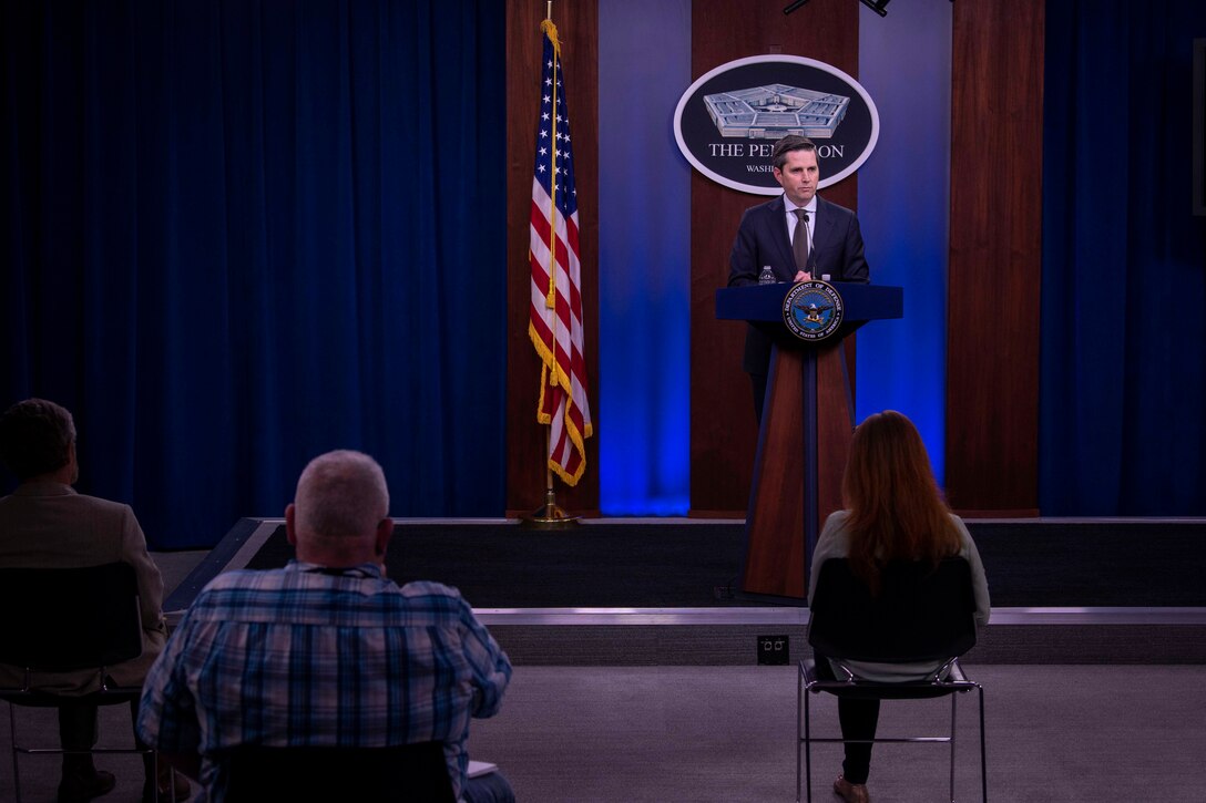 A man stands at a podium and talks.
