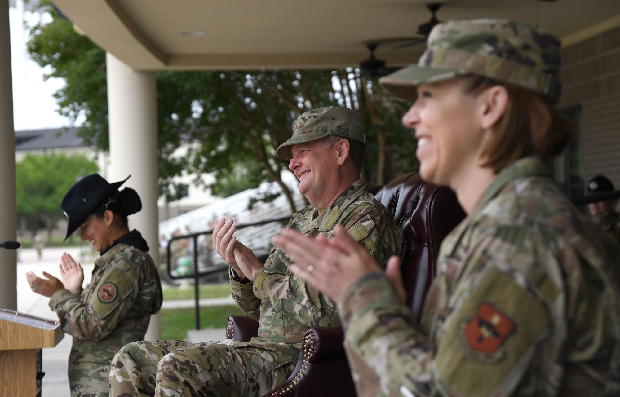 U.S. Air Force Lt. Gen. Brad Webb, commander of Air Education and Training Command, and Chief Master Sgt. Julie Gudgel, AETC command chief, applaud during the basic military training graduation ceremony at Keesler Air Force Base, Mississippi, May 15, 2020. Nearly 60 Airmen from the 37th Training Wing Detachment 5 completed the six-week basic military training course. Due to safety concerns stemming from COVID-19, the Air Force sent new recruits to Keesler to demonstrate a proof of concept to generate the force at multiple locations during contingencies. The flight was the first to graduate BMT at Keesler since 1968. (U.S. Air Force photo by Kemberly Groue)