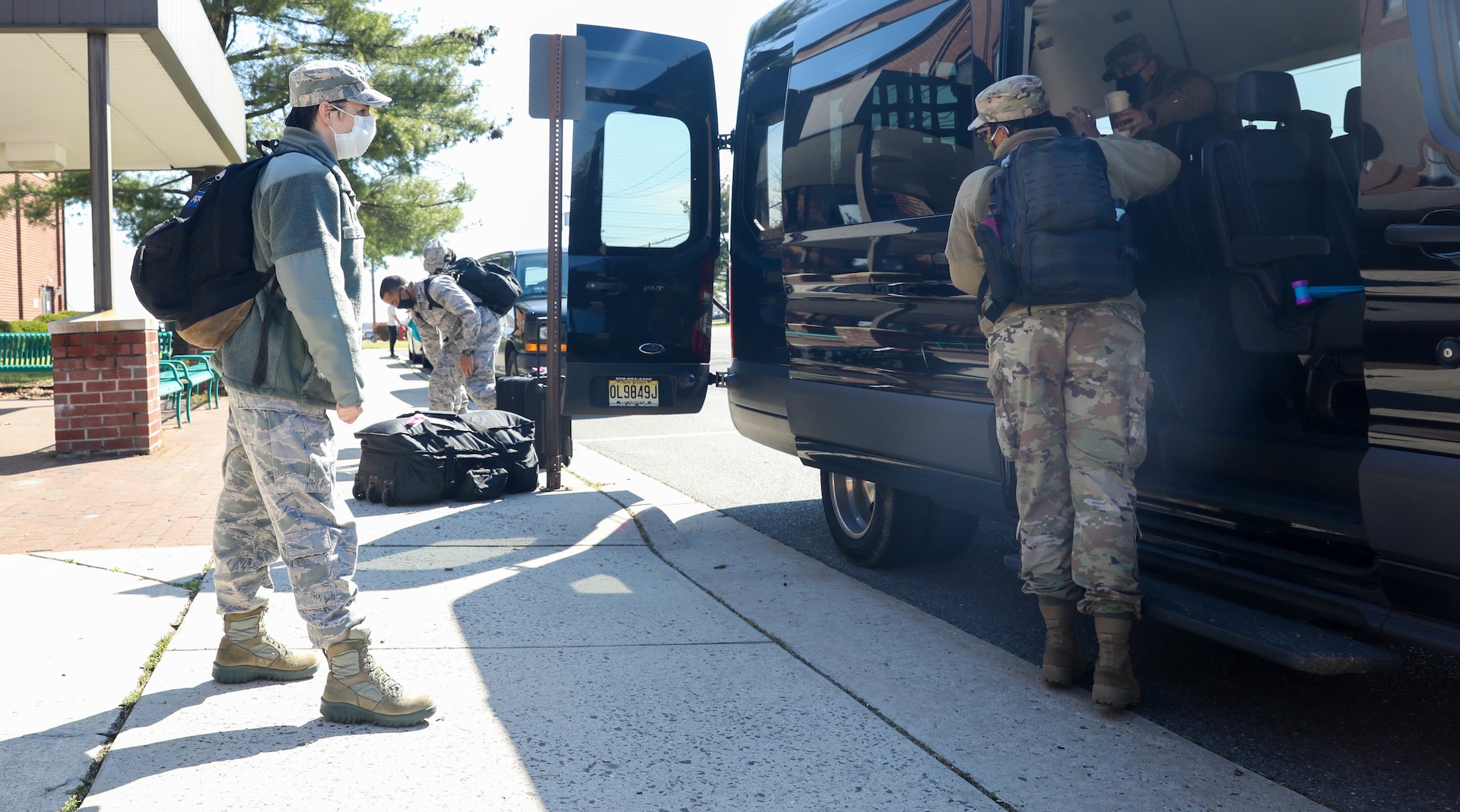 U.S. Air Force Lt. Col. Belinda Kelly, psychiatrist, 59th Medical Group, Lackland Air Force Base, Texas, maintains a safe distance of six feet behind Staff Sgt. Le’Aisha Smith, mental health technician, 59th Medical Group, Randolph Air Force Base, Texas, as they board a van at Joint Base McGuire-Dix-Lakehurst, NJ, April 28, 2020. Kelly and Smith are a part of a six-member team that will provide behavioral health and support services to the service men and women that are provide care and medical services to COIVD-19 patients. U.S. Northern Command, through U.S. Army North, is providing military support to the Federal Emergency Management Agency to help communities in need. (U.S. Army photo by Sgt. Aimee Nordin)