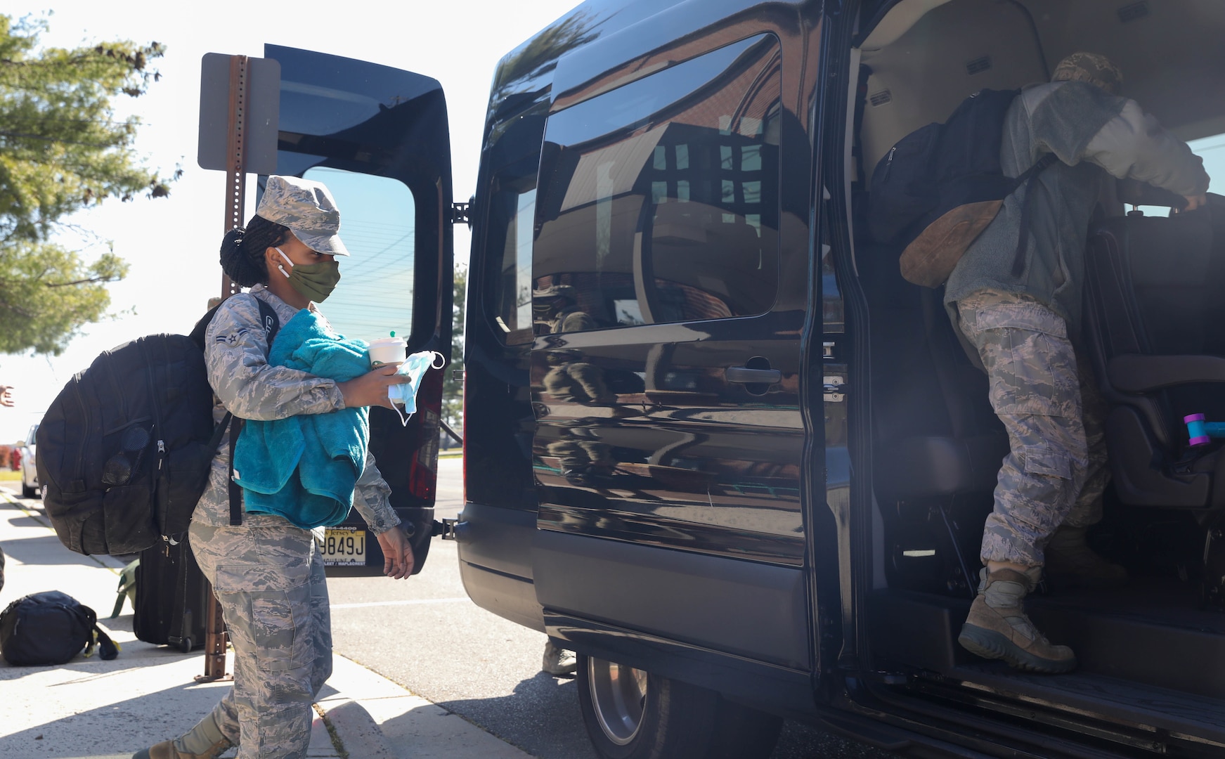 Airman 1st Class Tahlia Wilson, mental health technician, 59th Medical Group, Randolph Air Force Base, Texas, boards a van at Joint Base McGuire-Dix-Lakehurst, NJ, April 28, 2020. Wilson is a part of a six-member team that will provide behavioral health and support services to the service men and women that are provide care and medical services to COIVD-19 patients. U.S. Northern Command, through U.S. Army North, is providing military support to the Federal Emergency Management Agency to help communities in need. (U.S. Army photo by Sgt. Aimee Nordin)