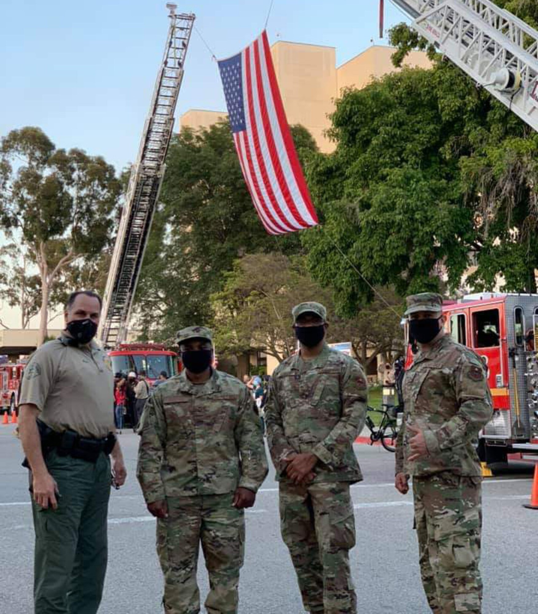 Air Force recruiters with the 369th Recruiting Squadron pose with a member of the Los Angeles Sheriffs department during the Salute to Heroes event May 13, 2020 in Los Angeles.