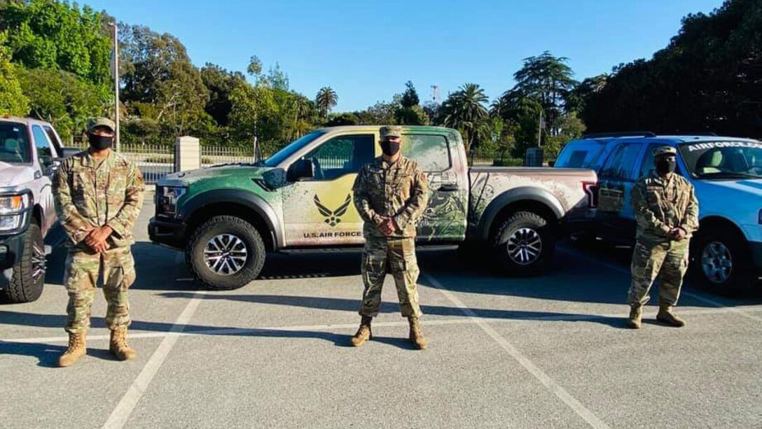 Air Force recruiters with the 369th Recruiting Squadron pose with their Air Force vehicles prior to driving in the Salute for Heroes event May 13, 2020 in Los Angeles.