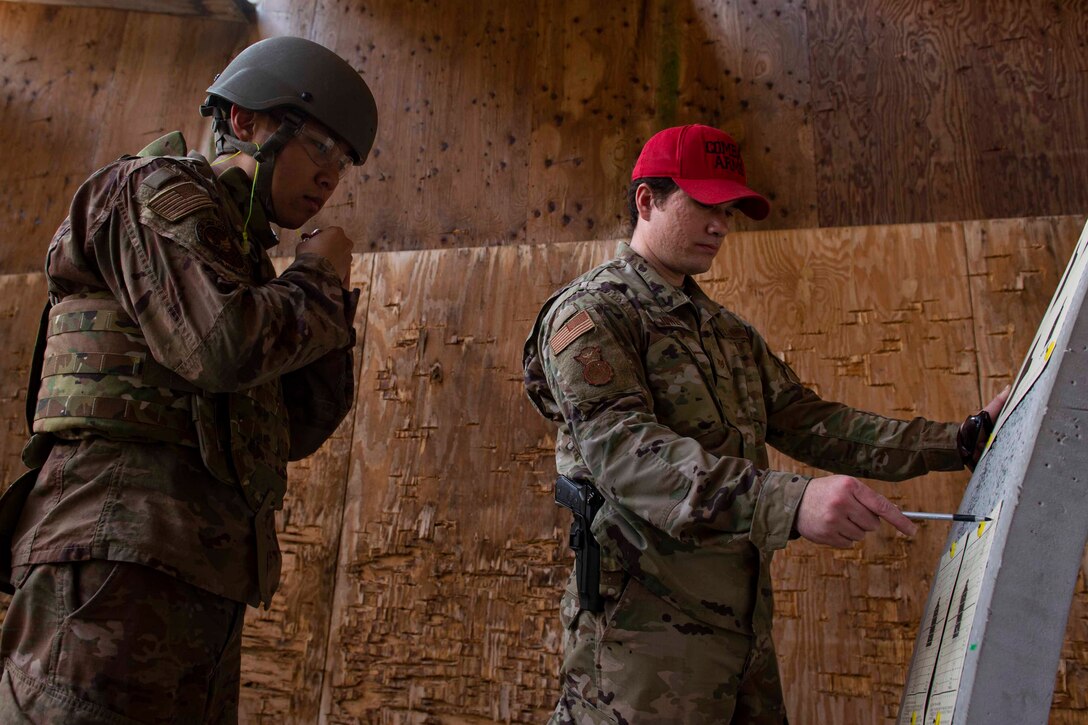 Photo of an Airman analyzing a target.