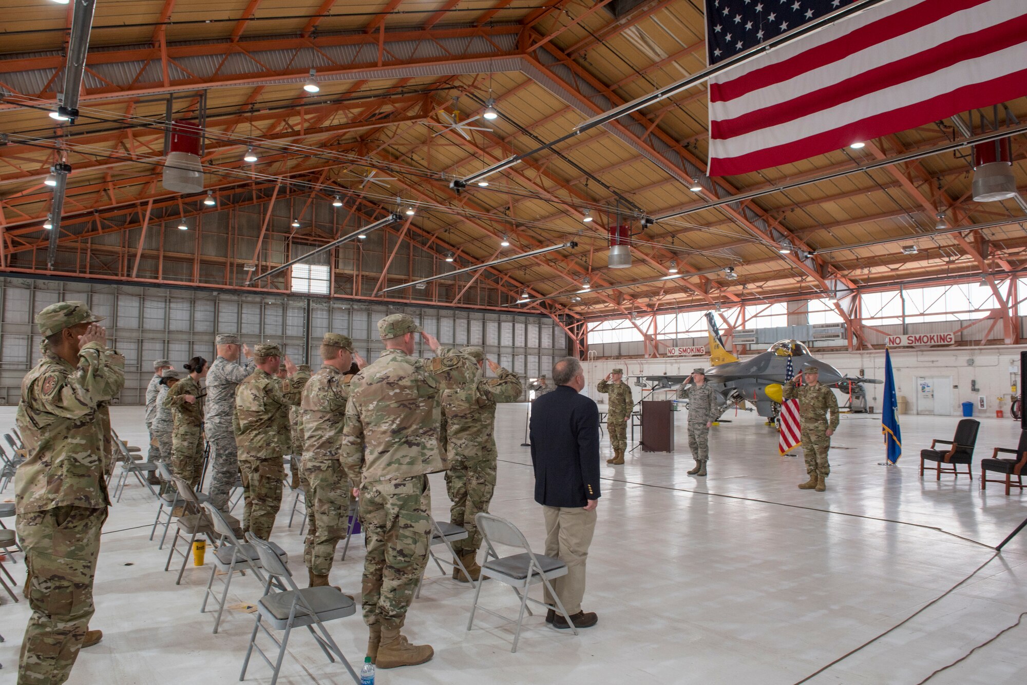 49th Wing Airmen render salutes during the National Anthem at the 49th Maintenance Group Change of Command ceremony May 15, 2020, on Holloman Air Force Base, N.M. Col. Joseph Campo, 49th WG commander, presided over the ceremony, at which Col. Tim Harbor, outgoing 49th MXG commander, relinquished command to Col. Thomas Preston, incoming 49th MXG commander. (U.S. Air Force photo by Staff Sgt. Christine Groening)