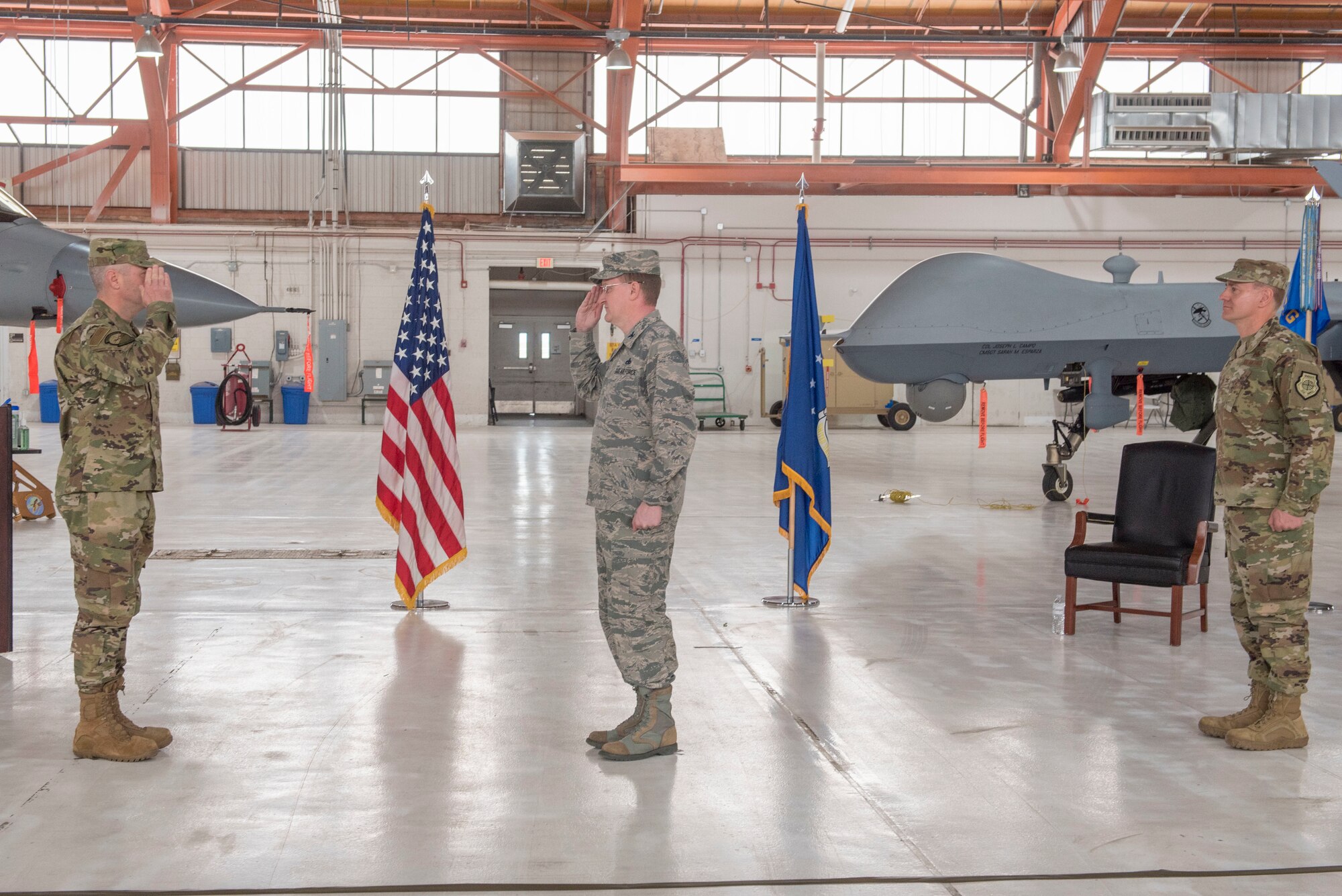 (Center) Col. Tim Harbor, outgoing 49th Maintenance Group commander, renders a salute to (left) Col. Joseph Campo, 49th Wing commander, as he relinquishes command of the 49th MXG, May 15, 2020, on Holloman Air Force Base, N.M. The 49th MXG consists of a team of over 2,100 Airmen, civilians and contractors from 23 specialties to produce disciplined maintenance and sortie-generation capabilities on F-16 Vipers, MQ-9 Reapers and their associated cockpits. (U.S. Air Force photo by Staff Sgt. Christine Groening)