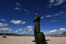 Mq-9 Reaper pilot stands in desert with Ranger ruck sack
