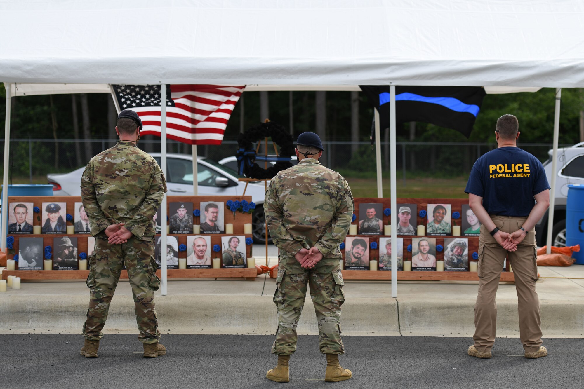 Airmen sanding at parade rest at a memorial