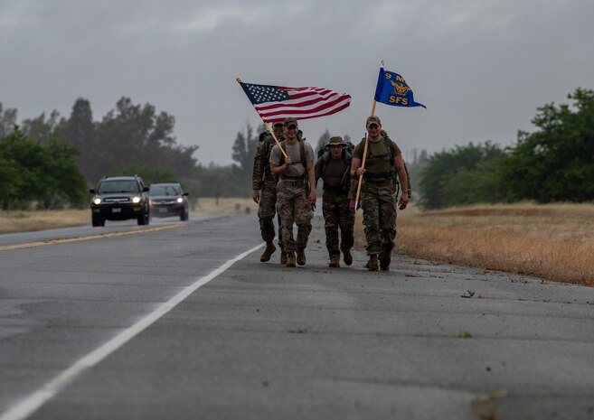 Airmen from the 9th Security Forces Squadron ruck alongside a road as part of Police Week.