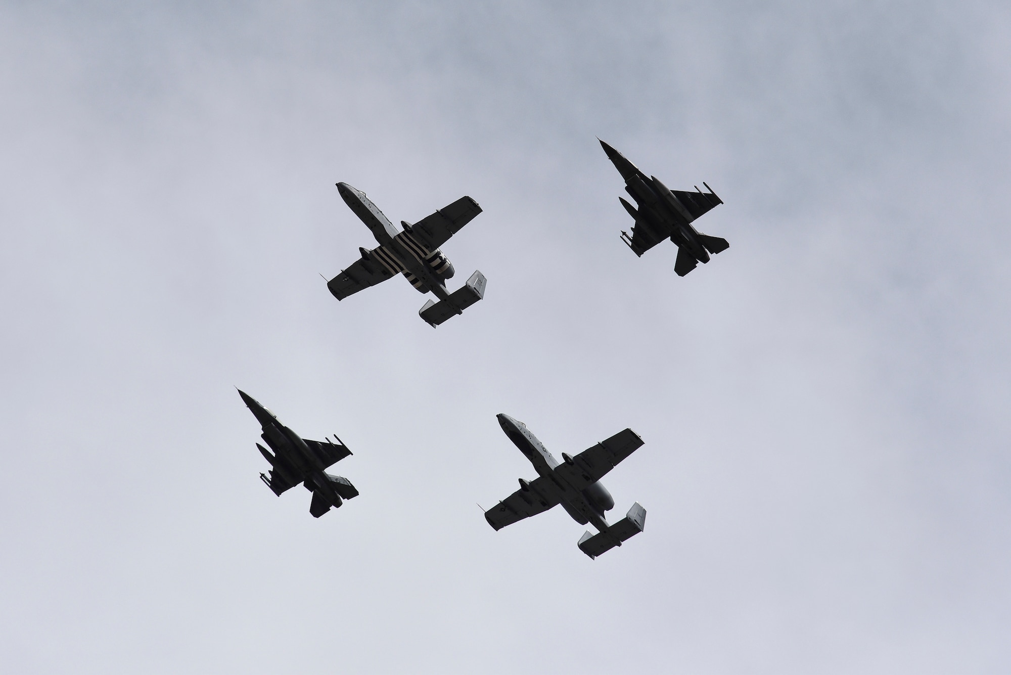 A photo of a four-ship formation performing a flyover.