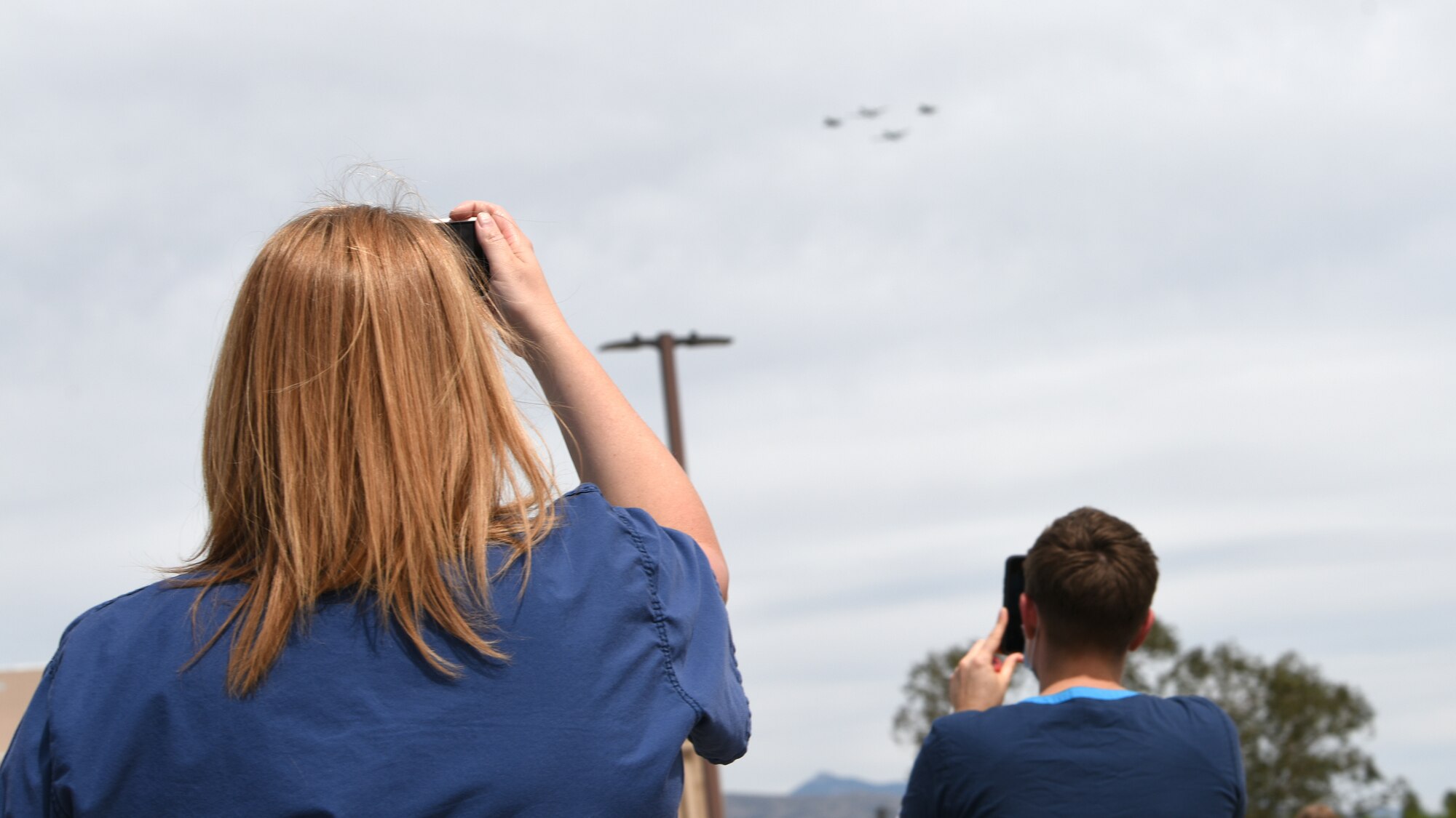 A photo of first responders recording a flyover.