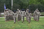 Military training instructors lead graduating Airmen onto the drill pad during the basic military training graduation ceremony at Keesler Air Force Base, Mississippi, May 15, 2020. Nearly 60 Airmen from the 37th Training Wing Detachment 5 completed the six-week basic military training course. Due to safety concerns stemming from COVID-19, the Air Force sent new recruits to Keesler to demonstrate a proof of concept to generate the force at multiple locations during contingencies. The flight was the first to graduate BMT at Keesler since 1968. (U.S. Air Force photo by Kemberly Groue)