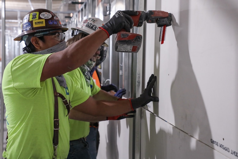 A contractor attaches a section of sheet rock to the frame of one of the pods May 11, of what will be an alternate care facility in Kalispell, Mont. The state of Montana requested FEMA to task the U.S. Army Corps of Engineers, Omaha District, to build the ACF on the vacant, undeveloped, third floor of Montana Children’s, the new pediatric facility of the Kalispell Regional Medical Center. The temporary facility would accommodate non-acute patients in case Montana faces an increase in COVID-19 patients in the fall. When completed, the ACF will have 98 patient care rooms, seven nurse’s station, four restrooms, three pharmacies and a medical supply storage room.