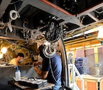 Jonathan Lopez (right) and Michael Lee, aircraft electricians in the assembly repair division at the Corpus Christi Army Depot, Texas, install the data concentrator units wiring as part of the UH-60L to UH-60V helicopter upgrade. (U.S. Army photo by Ervey Martinez)