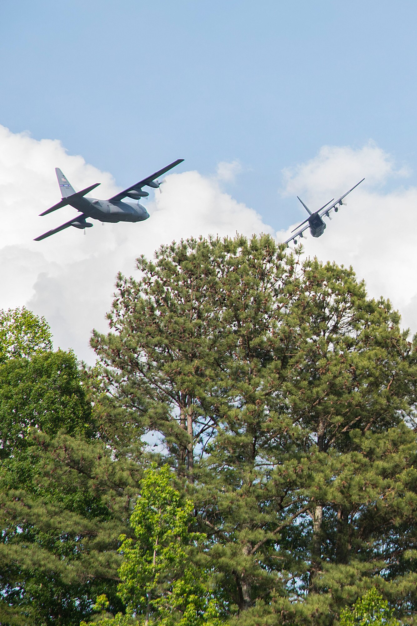 Two C-130H3 Hercules from Dobbins perform a flyover for Piedmont Mountainside hospital in Jasper, Ga. on May 14, 2020. The hospital flyover was one of several that day, serving as a way of saying thanks for all the tireless work healthcare workers and first responders have put in to help keep Georgia safe. (U.S. Air Force photo/Andrew Park)