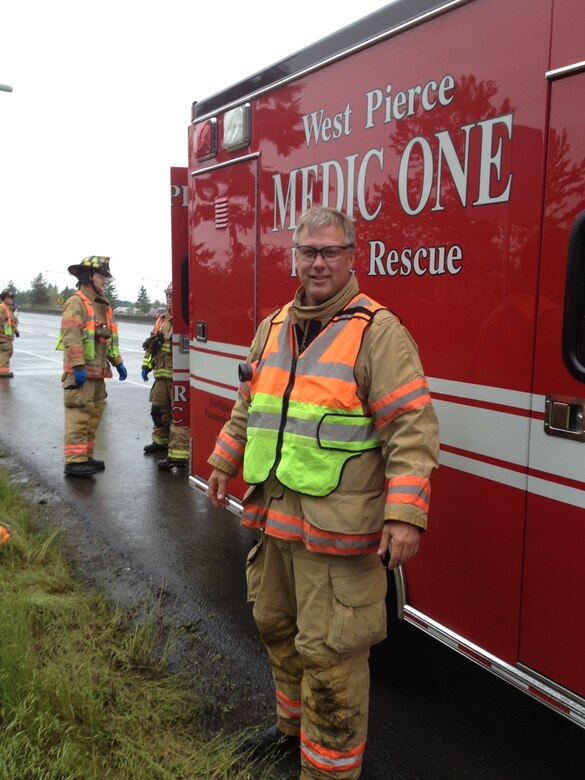 Reservist pose in front of firetruck