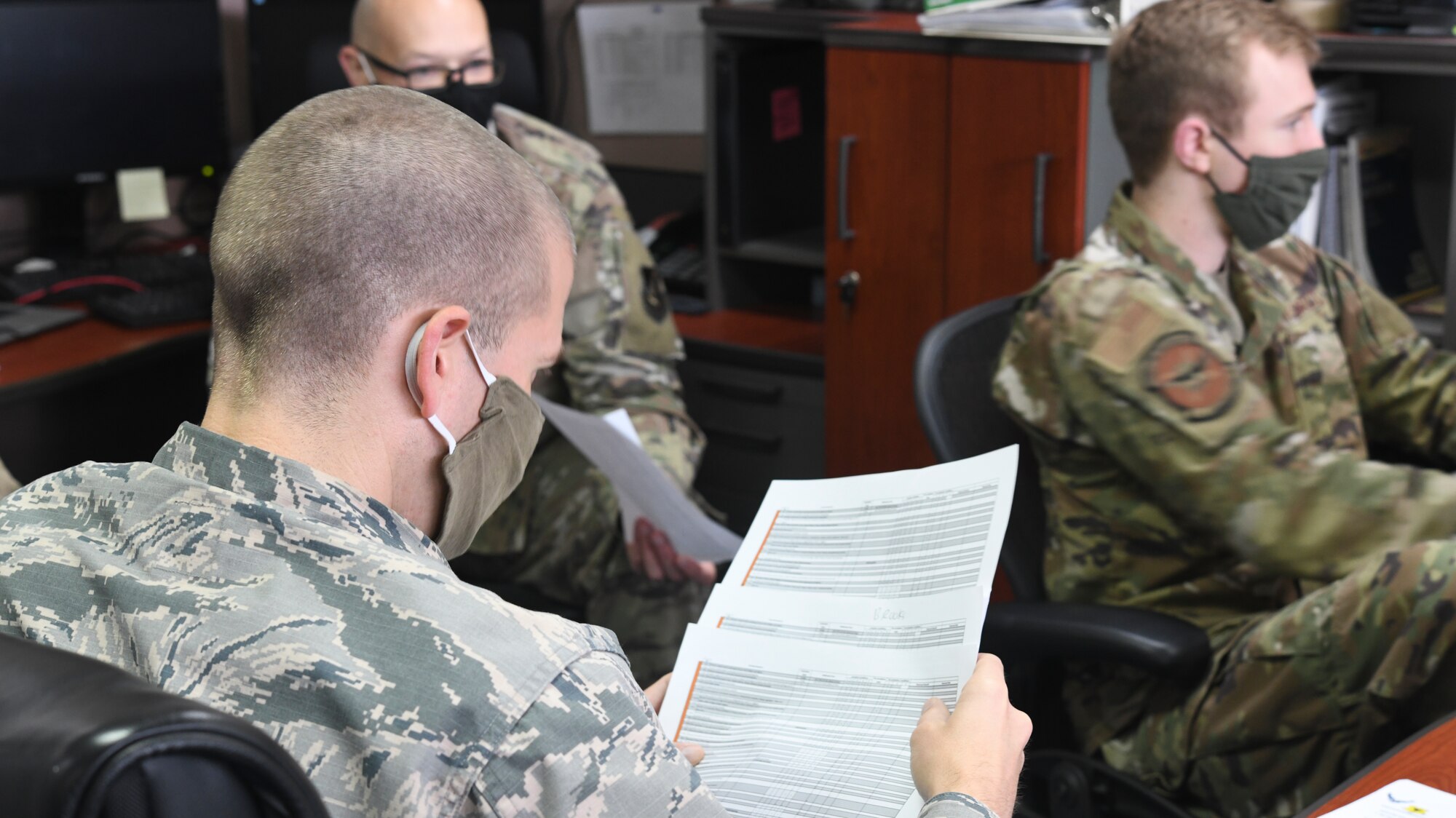 Members of the Future Operations team analyze COVID-19 data at an emergency operations center, May 6, 2020, at Kadena Air Base, Japan. Members of FUOPS are responsible for providing 18th Wing leaders all information relevant to decision-making that ensures force protection and mission readiness during counter-COVID-19 operations. (U.S. Air Force photo by Staff Sgt. Kristan Campbell)