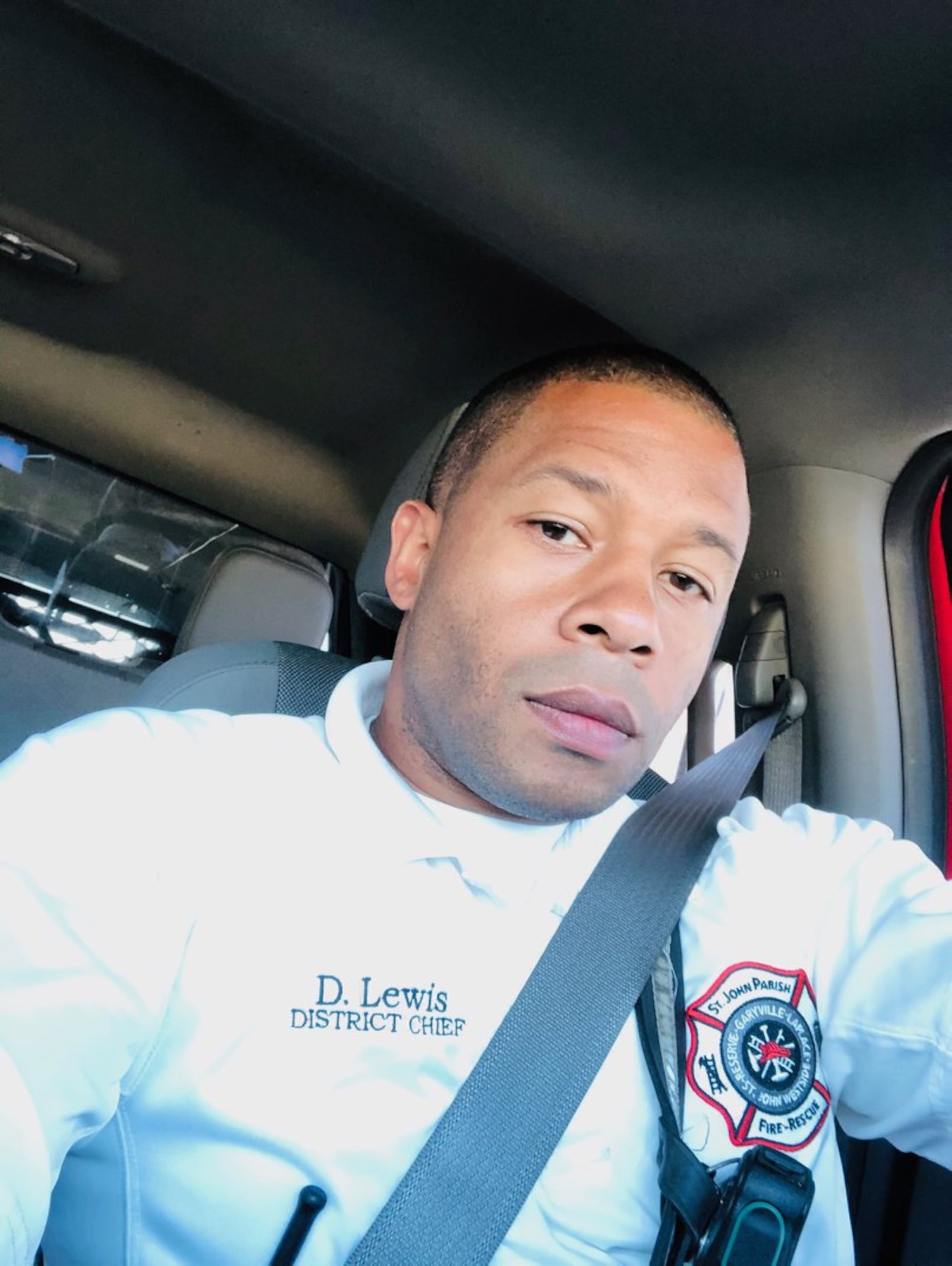 Damien Lewis, St. Johns Parish fire department district fire chief, poses for a photo in the fire truck. (courtesy photo)