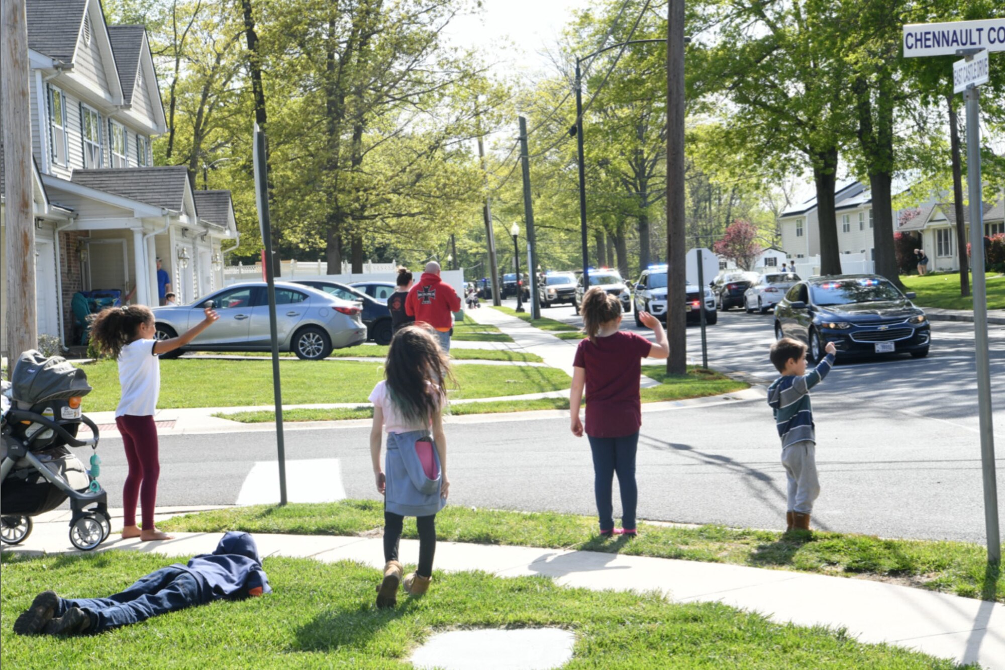 Children wave to law enforcement officers during the Cops For Kids Parade at Joint Base McGuire-Dix-Lakehurst, N.J., May 13, 2020. The parade was held in honor of National Police Week, observed from May 10-16. (U.S. Air Force photo by Tech. Sgt. Luther Mitchell)
