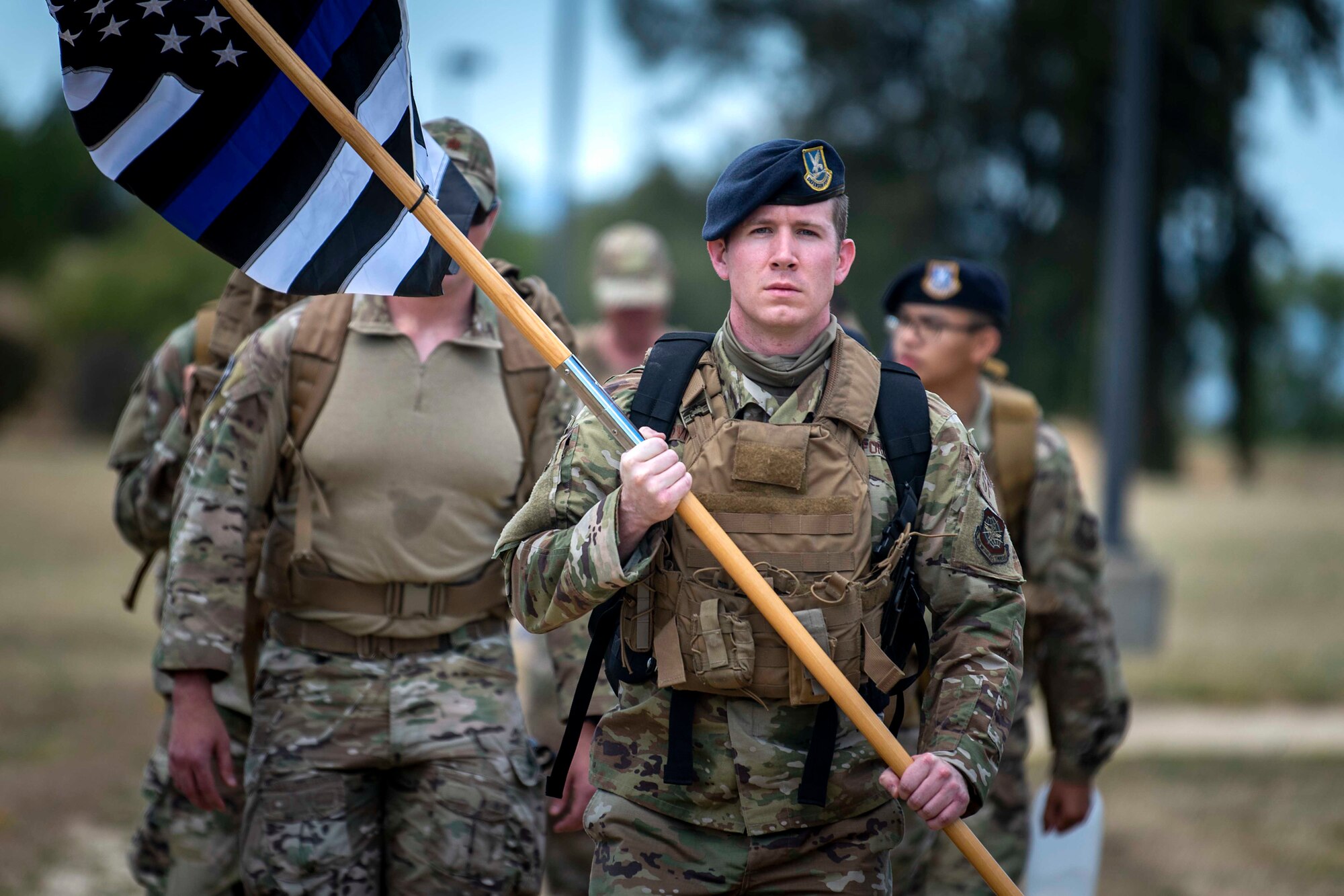 Photo of service members marching on track.