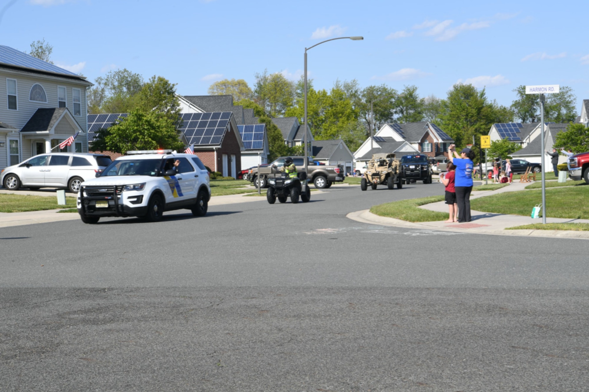 Photo of police cars driving through a housing development.