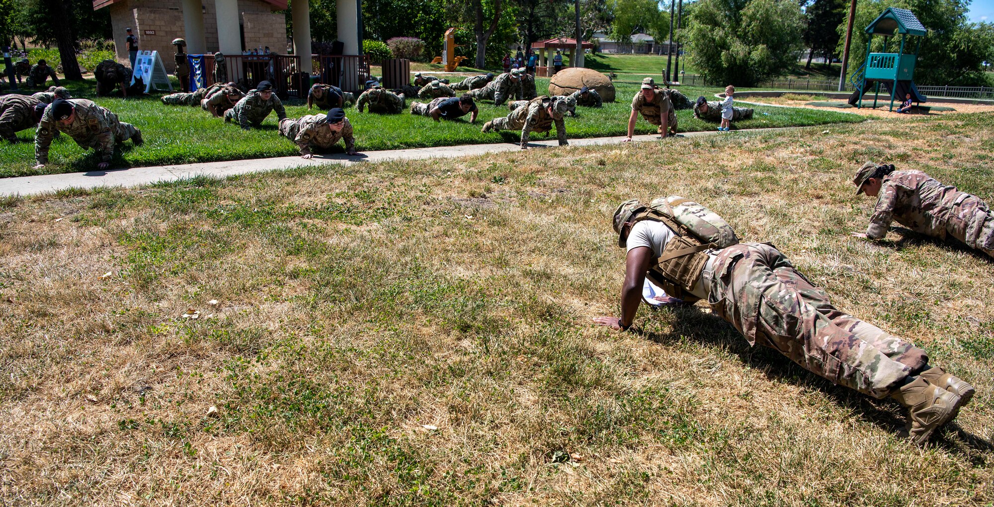 Photo of security forces members doing push-ups.