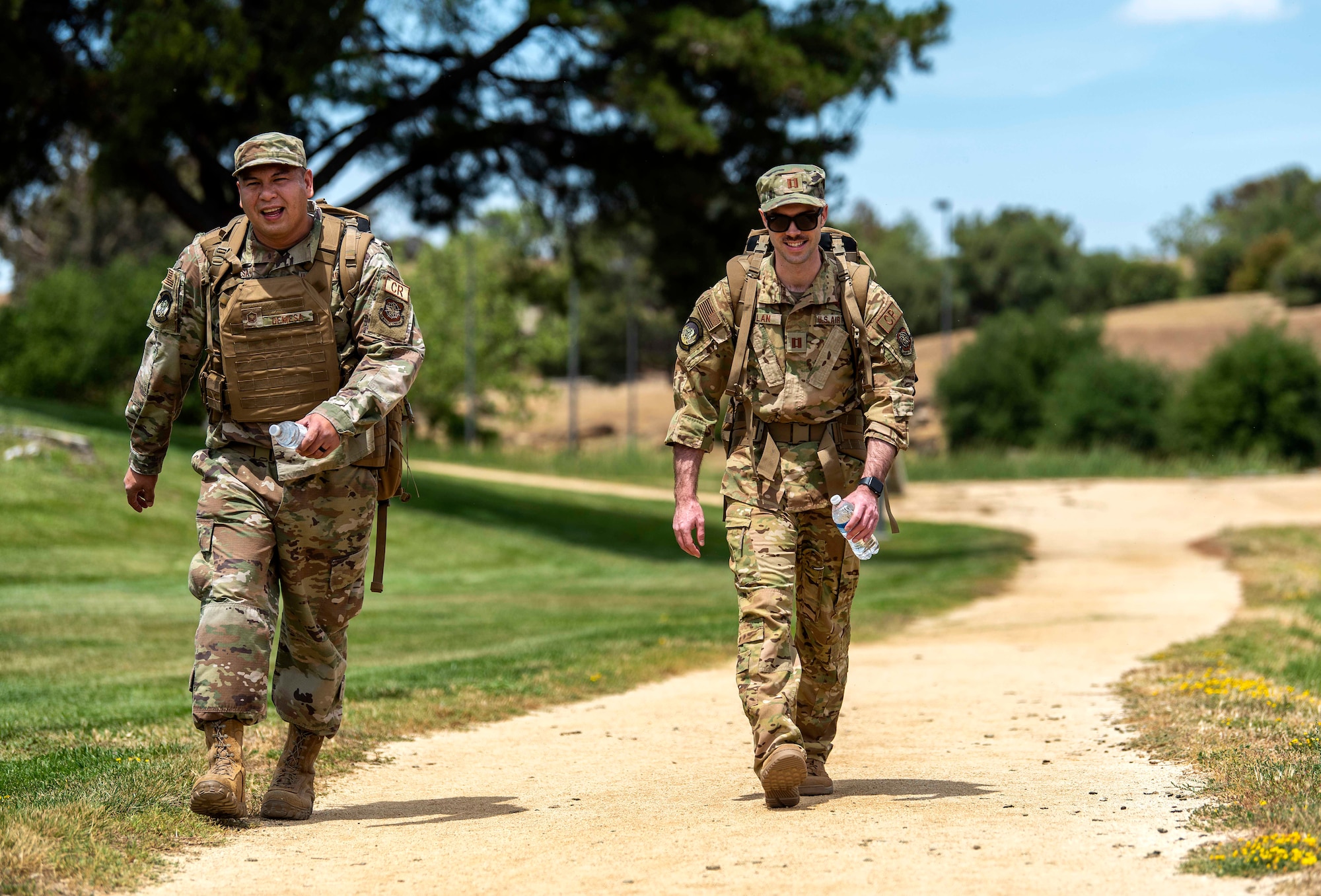 Photo of two service members on a ruck march.