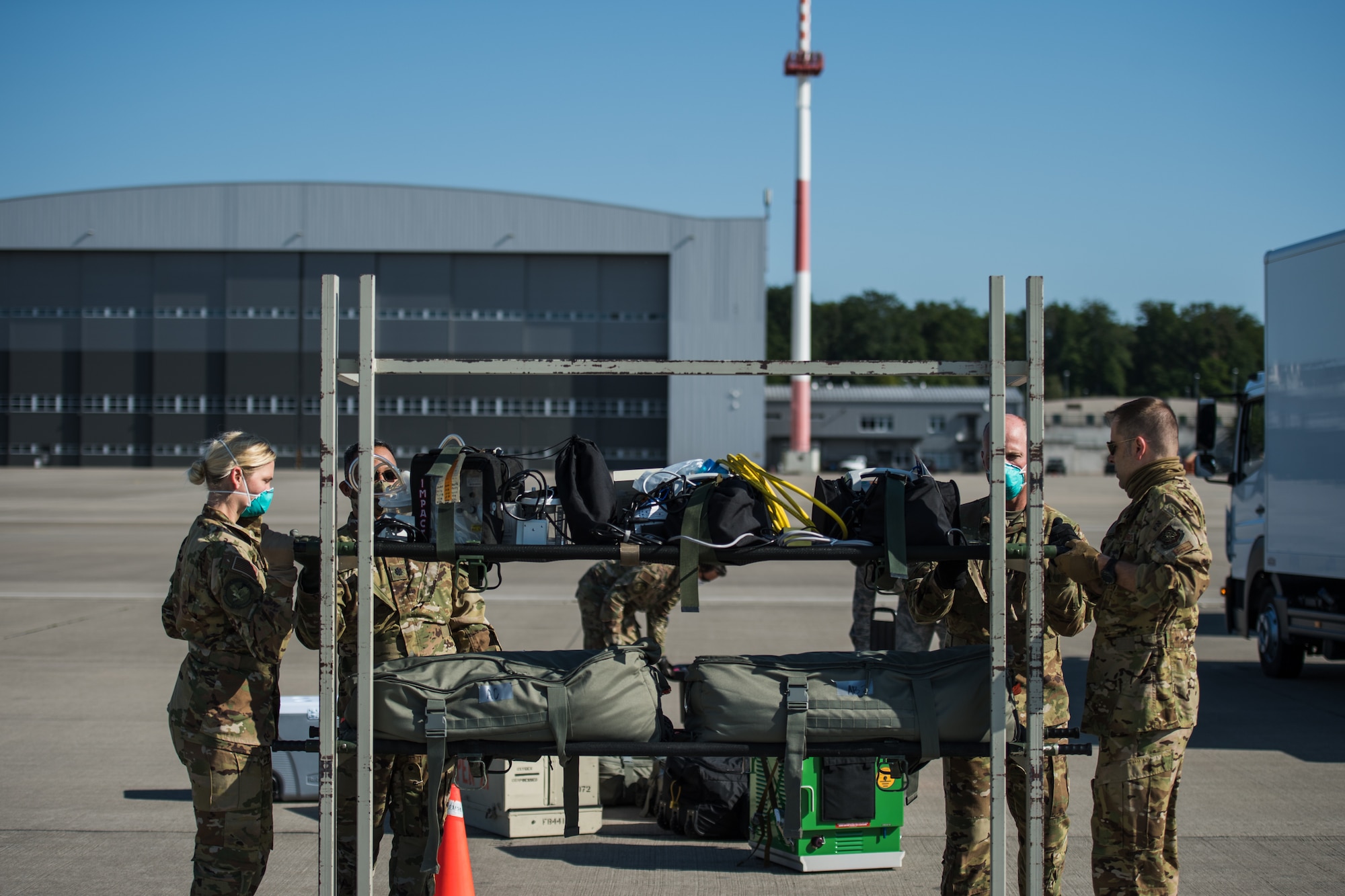 U.S. Airmen assigned to the 313th Expeditionary Operations Support Squadron load their medical supplies to return to their squadron after successfully transferring COVID-19 patients to Ramstein Air Base, Germany, May 16, 2020.