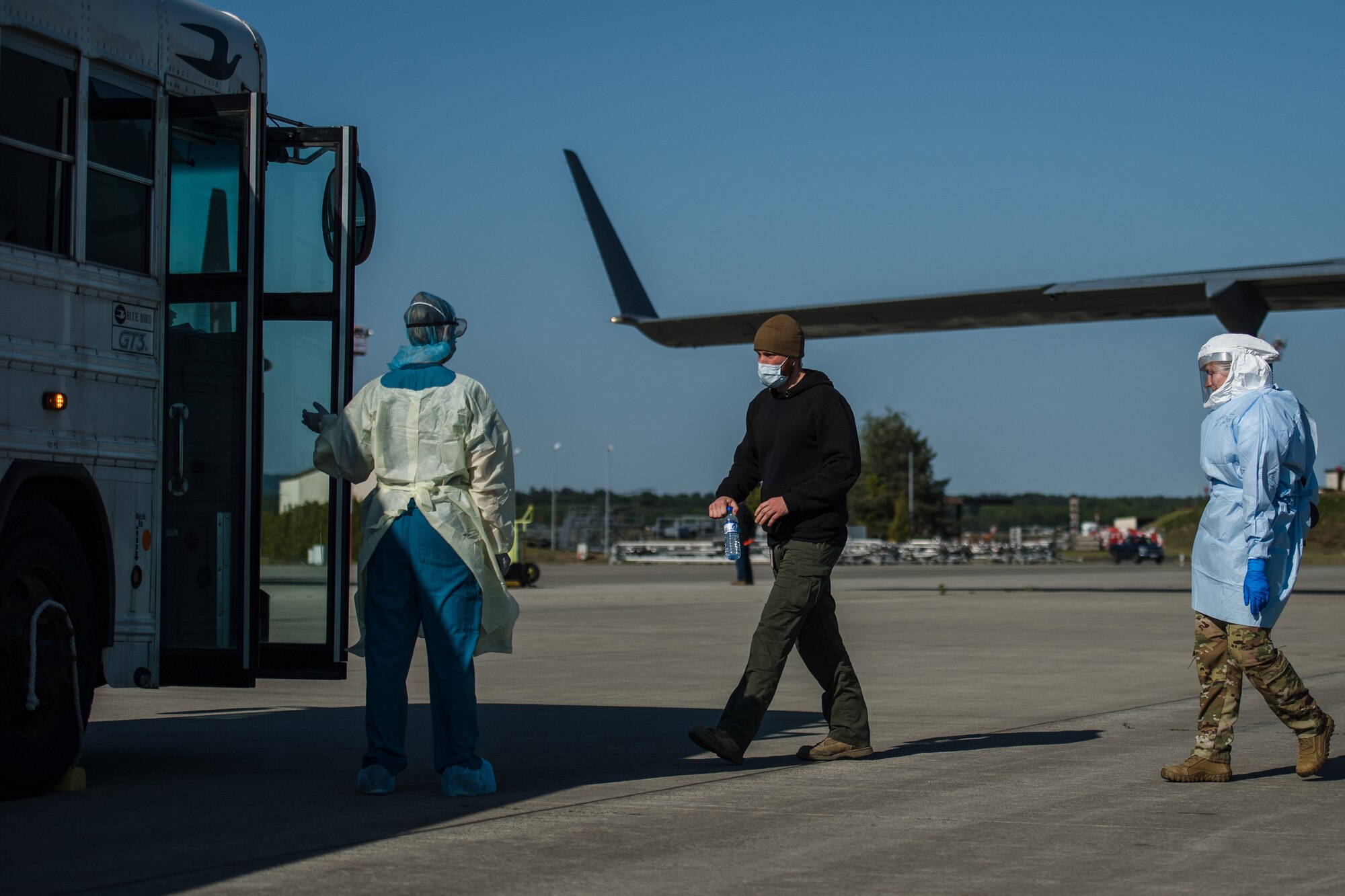 A COVID-19 patient boards an ambulance bus at Ramstein Air Base, Germany, May 16, 2020, after arriving from Afghanistan aboard a C-17 Globemaster III.