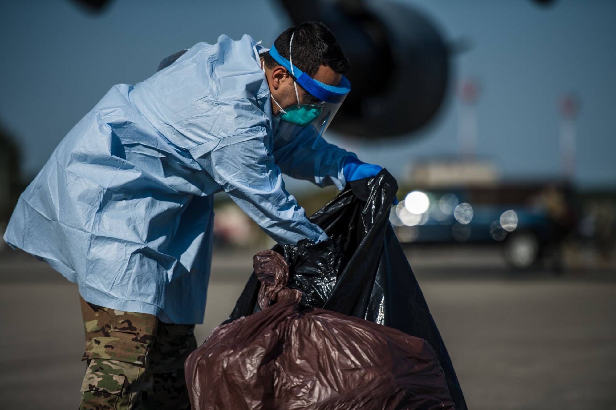 U.S. Air Force Senior Airman Danny Abad, 313th Expeditionary Operations Support Squadron aeromedical evacuation technician, sorts through COVID-19 patients’ belongings at Ramstein Air Base, Germany, May 16, 2020.