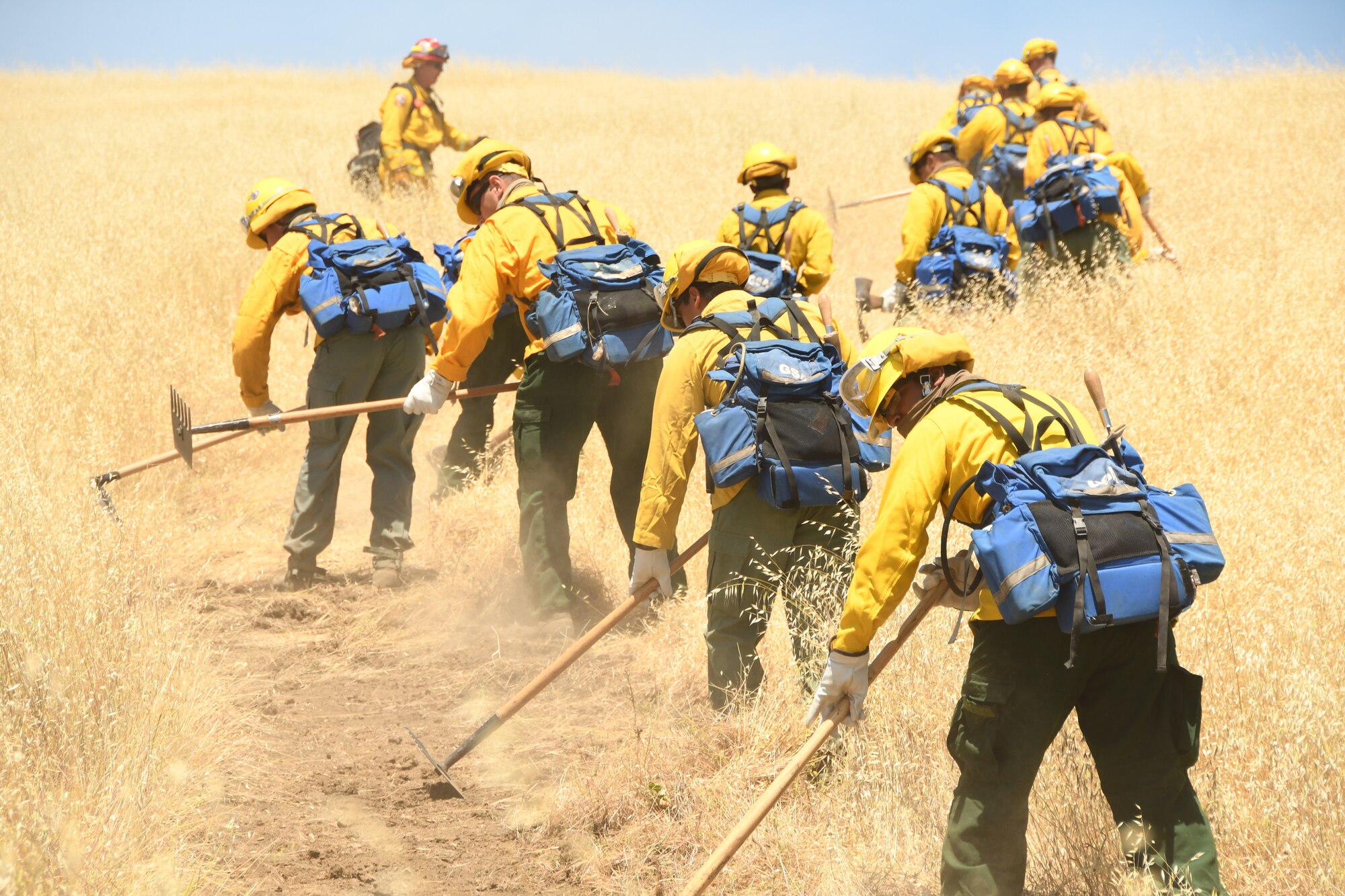 Cal Guardsmen practice cutting fire lines during hand crew training at Camp Roberts on May 14, 2020.