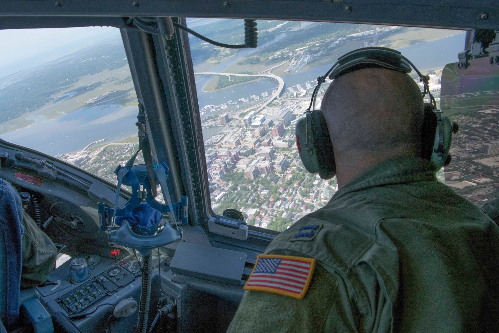 Captain Mike Mothena, Pilot, 315th Airlift Wing, Joint Base Charleston, South Carolina, looks down at medical facilities in Downtown Charleston, May 15, 2020. The flyover was part of OPERATION: AMERICA STRONG, a Salute to medical workers and first responders on the ground.