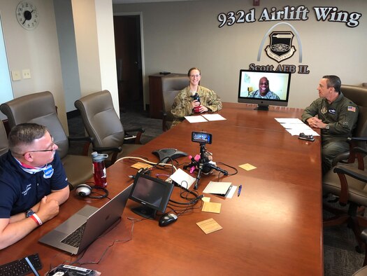 Christopher Parr, public affairs specialist, monitors a social media “live” session with Lt. Col. Mellissa Steckler, 932nd Aeromedical Evacuation Squadron commander; Col. Caleb King, 932nd Aeromedical Staging Squadron commander; and Lt. Col. Brandon Lorton, 73rd Operations Squadron commander, on May 14, 2020, at Scott Air Force Base, Ill. They took turns talking about leadership during the COVID-19 situation.  (U.S. Air Force photo by Lt. Col. Stan Paregien)