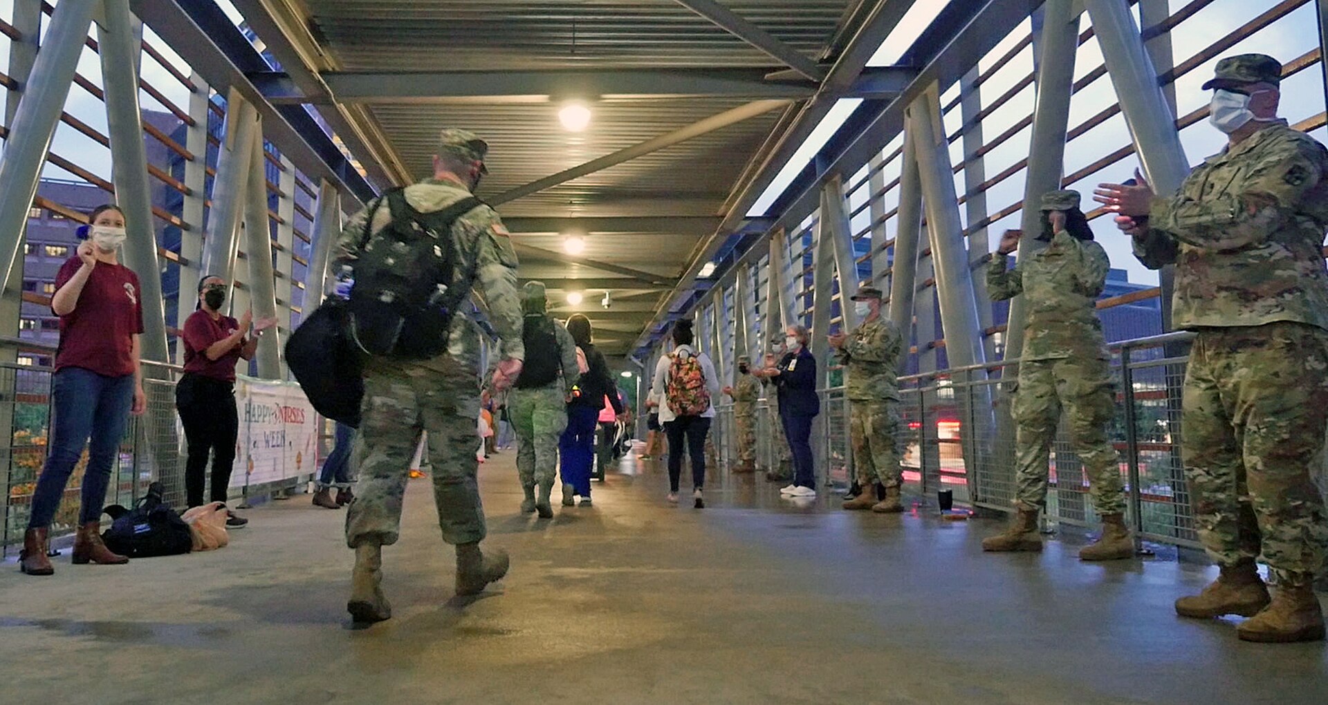Staff members from the Brooke Army Medical Center’s critical care department line the walkway to greet and cheer on BAMC staff members as they come to work May 12. The critical care department chose the date – which is both the end of Nurses Week and Florence Nightingale’s birthday – to celebrate all the BAMC staff who work to ensure high quality care for patients.