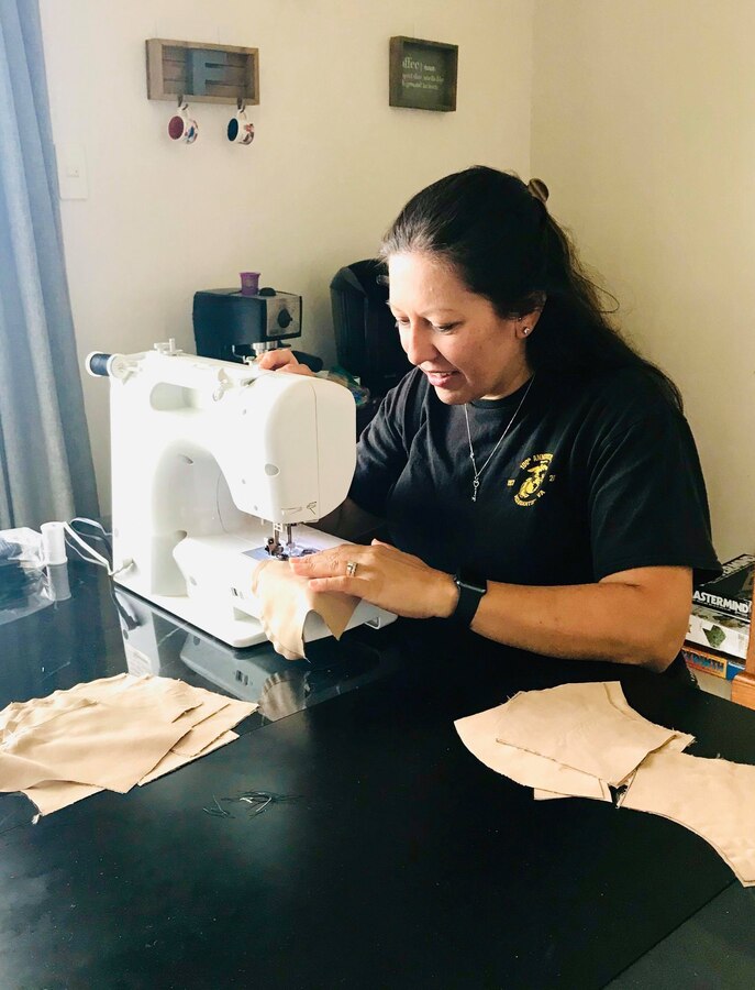Amy Fisher, one of the women who helped make masks for the 31st Marine Expeditionary Unit (MEU) Marines, sews masks at Camp Butler, Okinawa, Japan, April 24, 2020. Twelve women prepared 228 masks, spending 230 hours shopping for material, then cutting, sewing and assembling the masks for the Marines. The 31st MEU, the Marine Corps' only continuously forward-deployed MEU, provides a flexible and lethal force ready to perform a wide range of military operations as the premier crisis response force in the Indo-Pacific region. (Courtesy photo by Kristen Brodie)