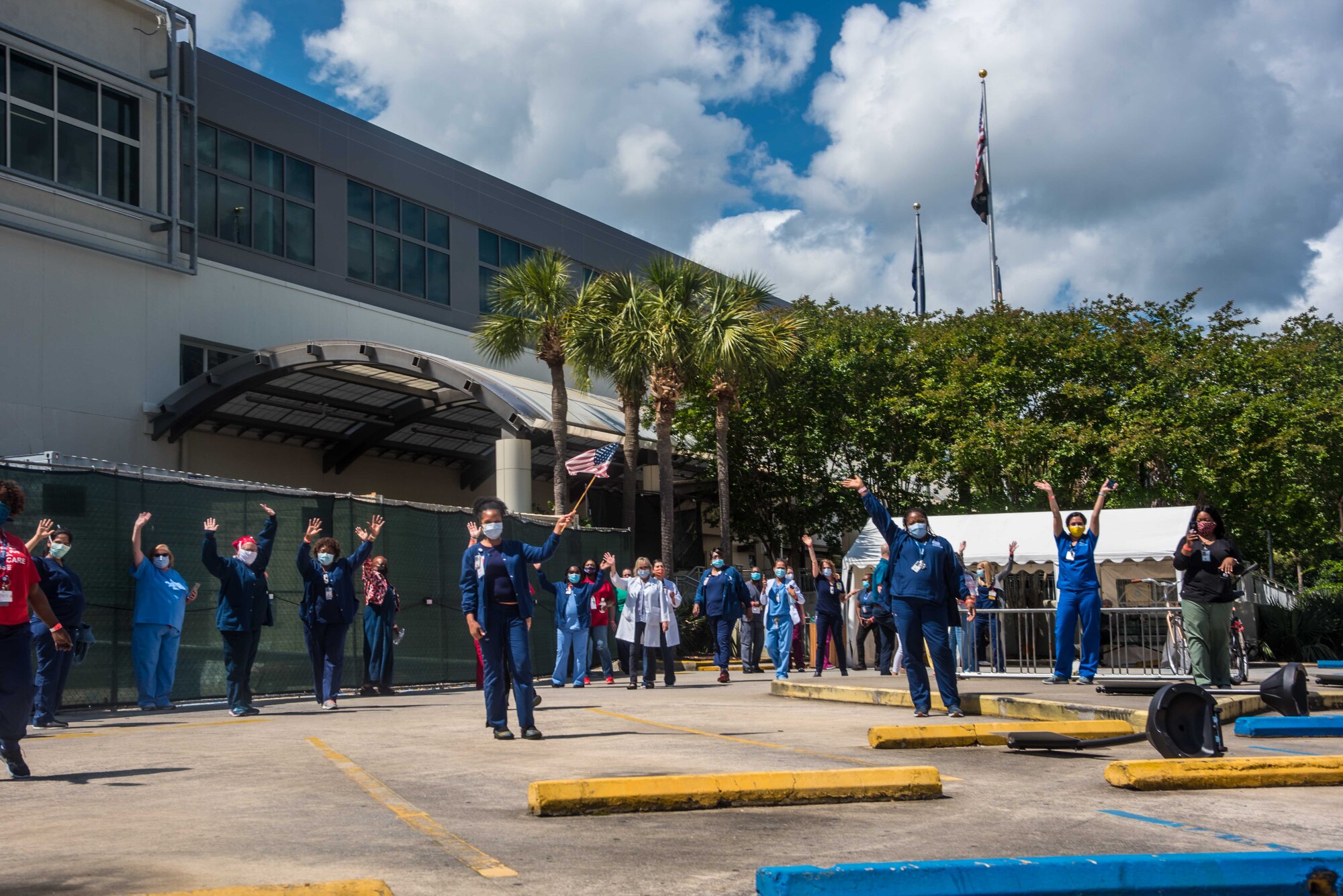 Healthcare workers waved at the Joint Base Charleston C-17 Globemaster III's during a flyover saluting healthcare workers in the fight against COVID-19, May 15, 2020, at Ralph H. Johnson VA Medical Center in Charleston, South Carolina. Two C-17 Globemaster IIIs from Joint Base Charleston’s 437th and 315th Airlift Wings here saluted local medical professionals and first responders during a flyover Friday.