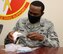 Tech. Sgt. Sean Holder, 50th Contracting Squadron contracting officer, removes part of a mask and a tension release band from a bag May 14, 2020 at Schriever Air Force Base, Colorado. Holder, along with Staff Sgt. Arron Riffle, 50th CONS contracting officer, purchased more than 1,400 masks and 10,000 tension release bands from vendors to prevent the spread of the coronavirus. (Air Force photo by Marcus Hill)