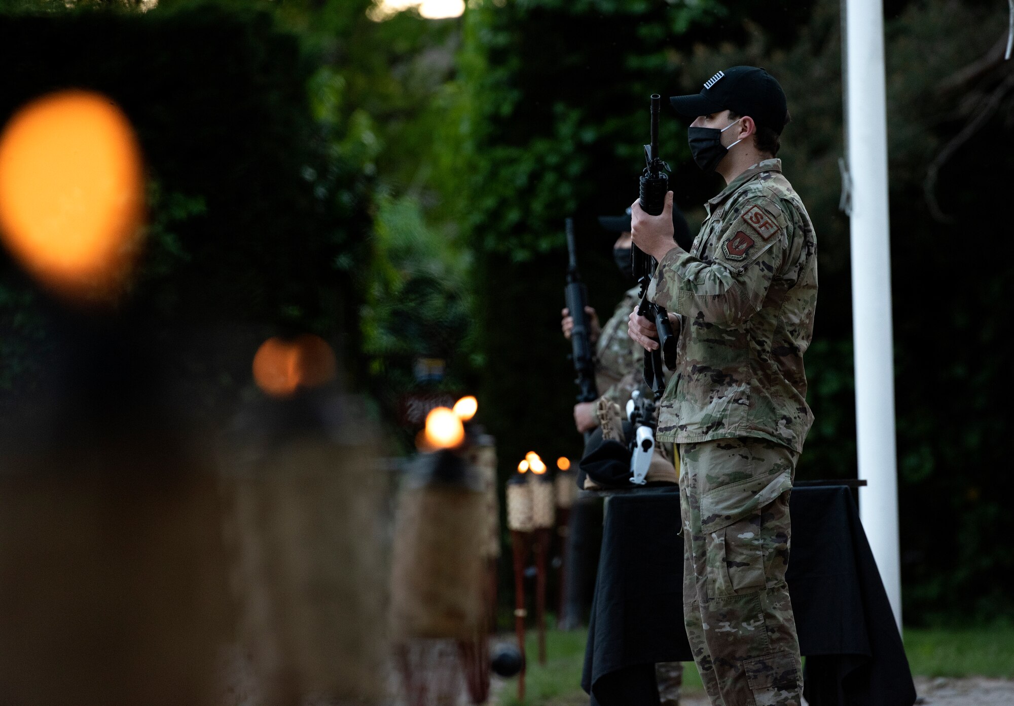 Airmen assigned to the 48th Security Forces Squadron stand guard over the memorial during a fallen warrior candlelight vigil in honor of National Police Week at Royal Air Force Lakenheath, England, May 14, 2020. In 1962, President John F. Kennedy signed Public Law 87-726 designating May 15 as Peace Officers' Memorial Day, and the week in which it falls as National Police Week. (U.S. Air Force photo by Airman 1st Class Jessi Monte)