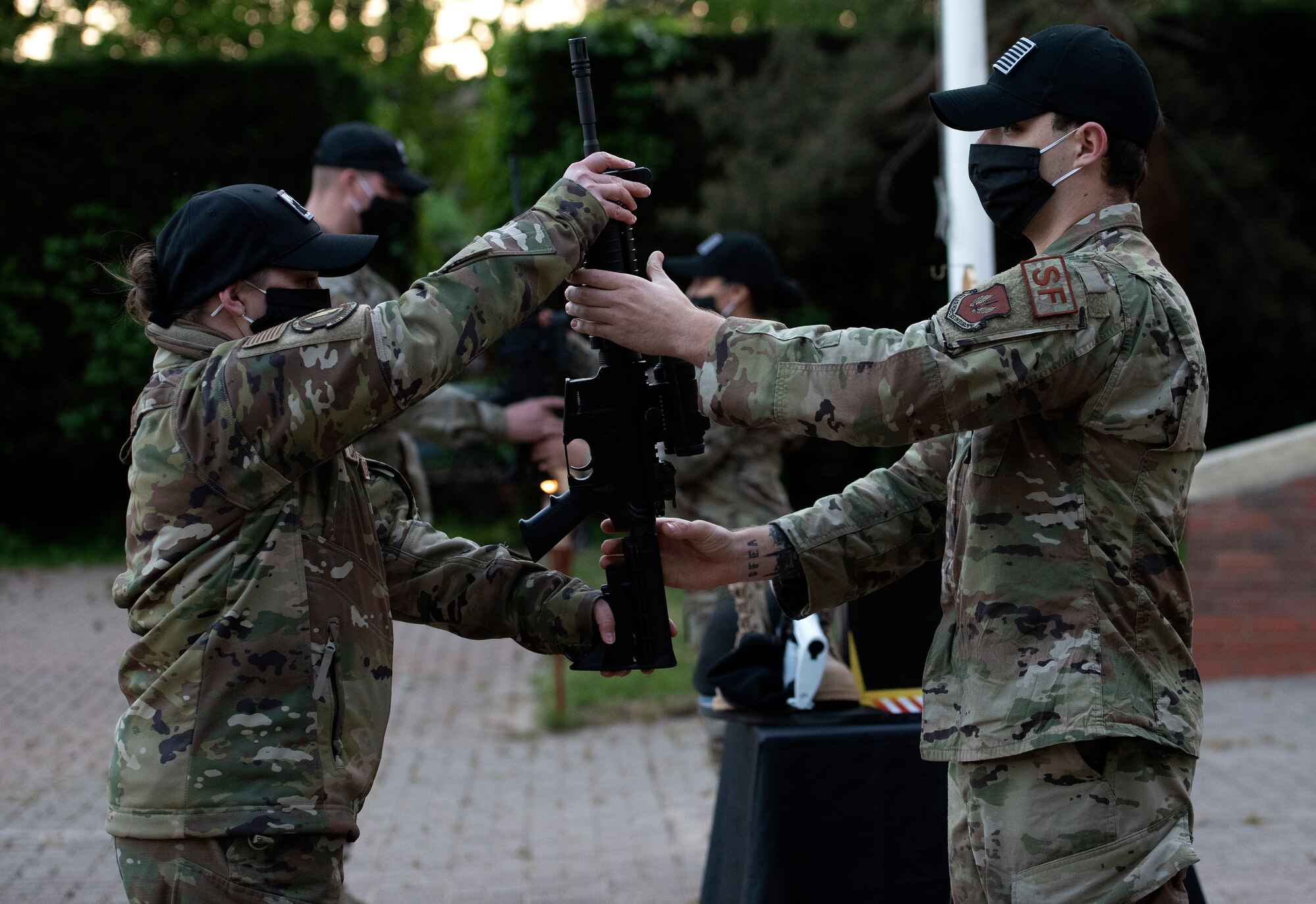 48th Security Forces Squadron Airmen perform a changing of the guard during a fallen warrior candlelight vigil in honor of National Police Week at Royal Air Force Lakenheath, England, May 14, 2020. National Police Week recognizes the service and sacrifice of law enforcement officers, paying special tribute to those who have lost their lives in the line of duty for the safety and protection of others. (U.S. Air Force photo by Airman 1st Class Jessi Monte)