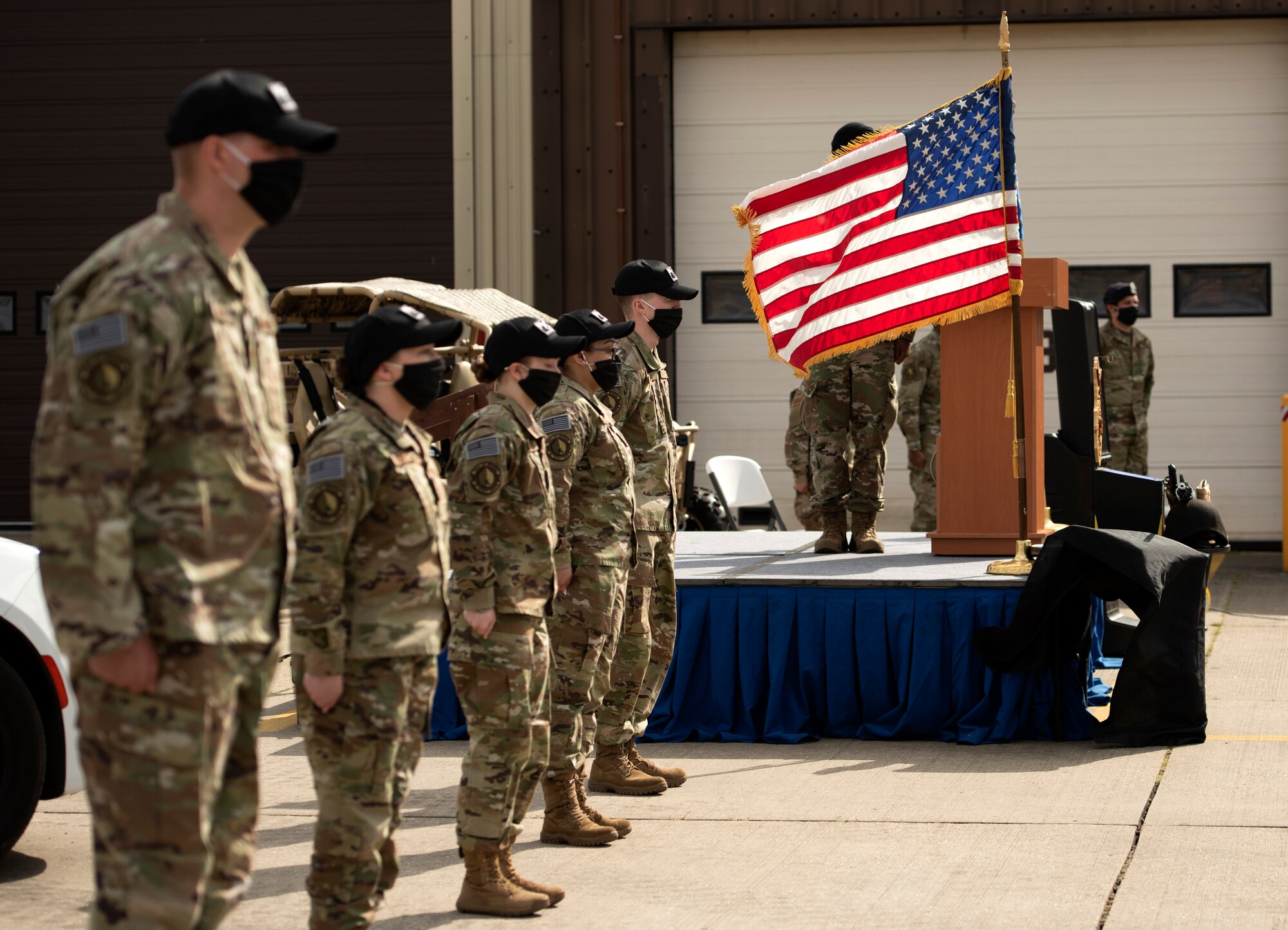 48th Security Forces Squadron Airmen stand at attention as the names of fallen Defenders are called out during a guardmount ceremony in honor of National Police Week at Royal Air Force Lakenheath, England, May 15, 2020. The symbolic final roll-call is performed to recognize and commemorate Defenders who have made the ultimate sacrifice and given their lives in the line of duty. (U.S. Air Force photo by Airman 1st Class Jessi Monte)