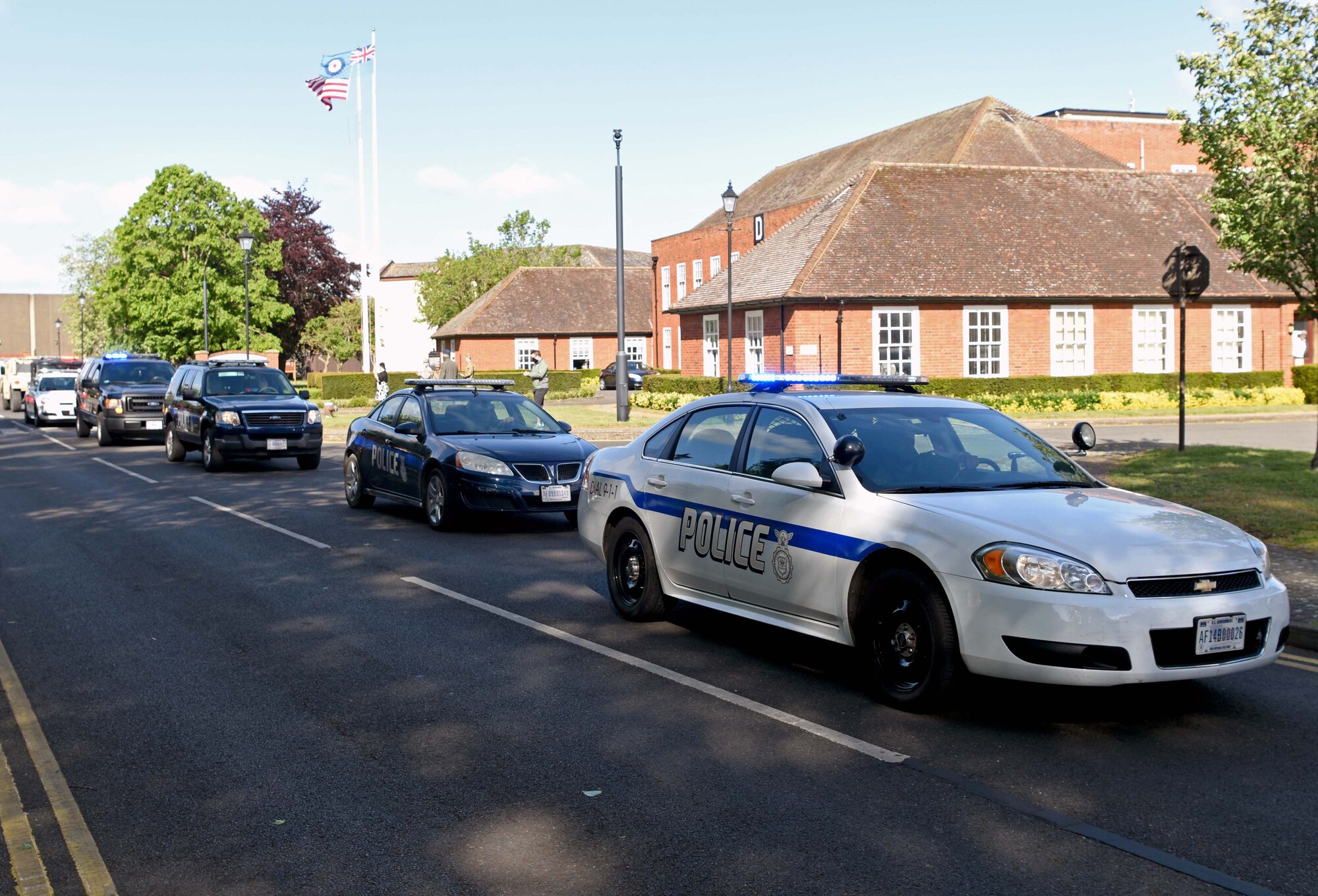 Vehicles from the 100th Security Forces Squadron proceed during a parade to kick-off National Police Week 2002 celebrations at RAF Mildenhall, England, May 11, 2020. National Police Week is an observance in the United States which pays tribute to local, state and federal officers who’ve died or who’ve been disabled in the line of duty. (U.S. Air Force photo by Senior Airman Brandon Esau)