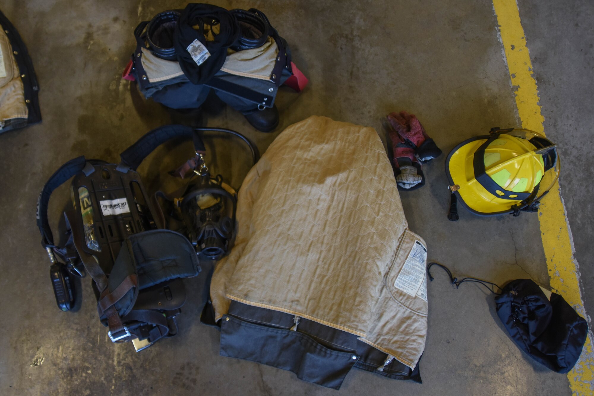Personal protective equipment used by the 22nd Civil Engineering Squadron’s firefighters lay out before being used in a bunker drill May 12, 2020, at McConnell Air Force Base, Kansas. Bunker drills test Airmen on their ability to quickly don all of their equipment in two minutes, training them to respond to emergencies rapidly. (U.S. Air Force photo by Airman 1st Class Marc A. Garcia)